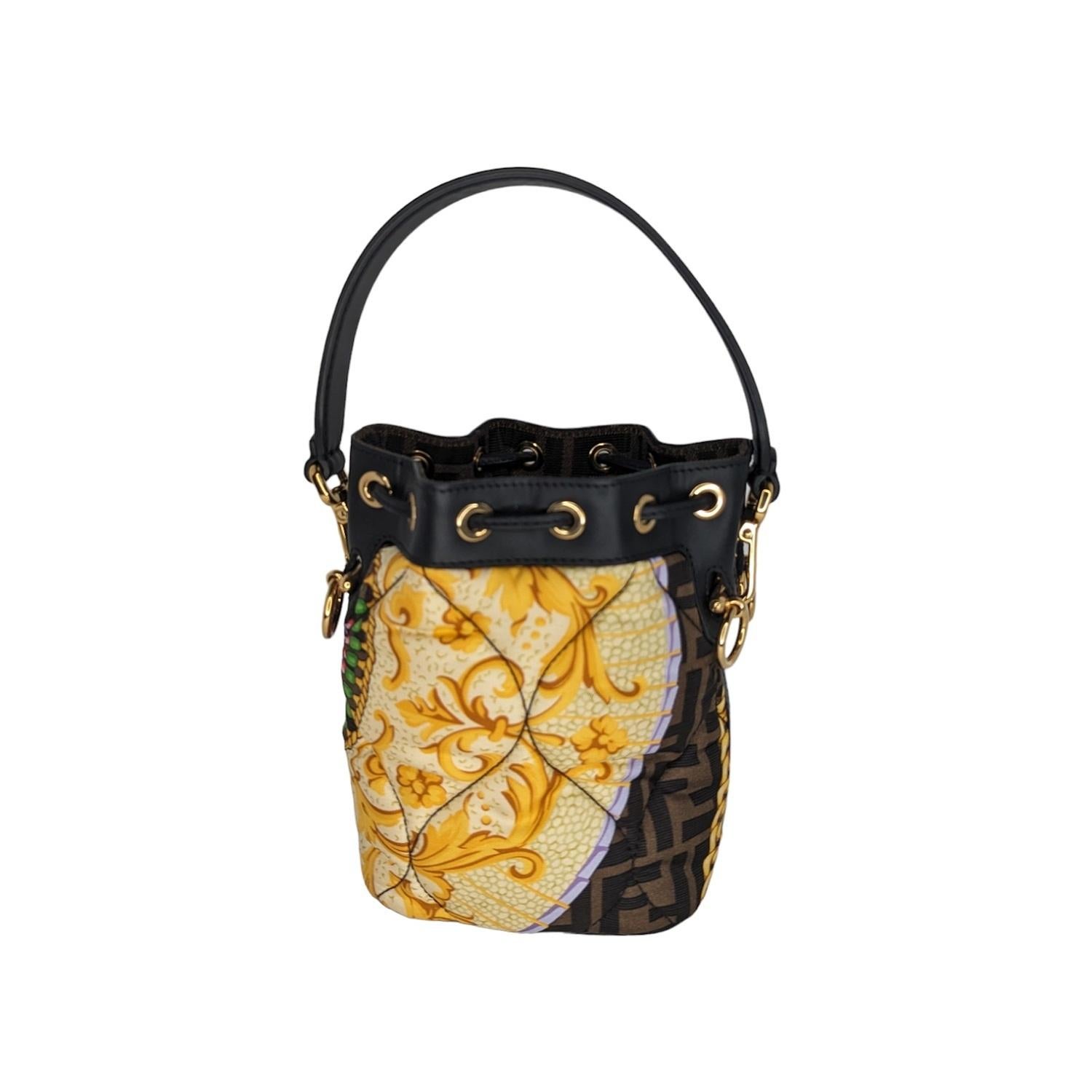 This chic tote is crafted of silk with the iconic Fendi FF logo with the Versace Baroque print in brown, black and gold. The bag features a black leather strap handle. The top opens to a Fendi logo print interior. Made in Italy. Retail price