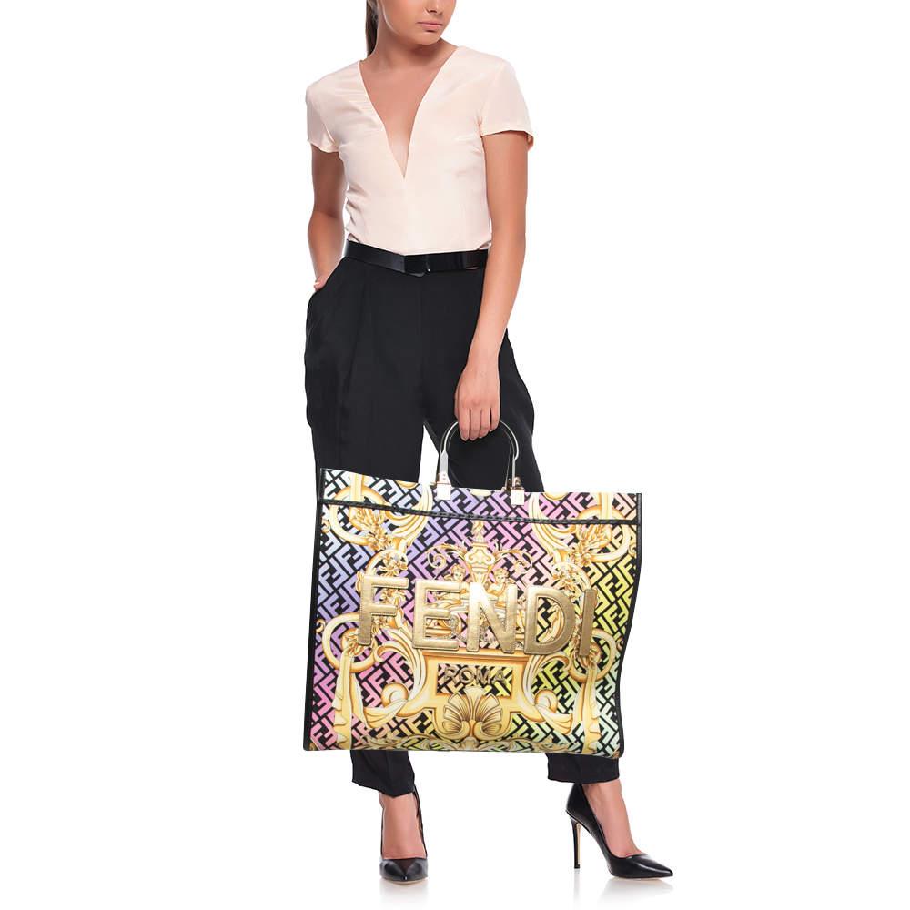 The Fendi x Versace Fendace Sunshine Tote is a stunning and vibrant accessory that showcases the fusion of two iconic fashion houses. This spacious tote features a lively baroque print on durable canvas, accented with luxurious leather details,
