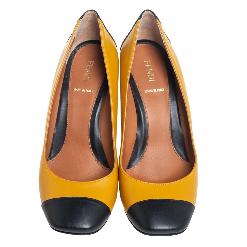 Endless compliments will come your way every time you wear these Fendi pumps. The yellow and black pumps are crafted from leather and styled with square cap toes and studded block heels. They are complete with comfortable leather insoles and will