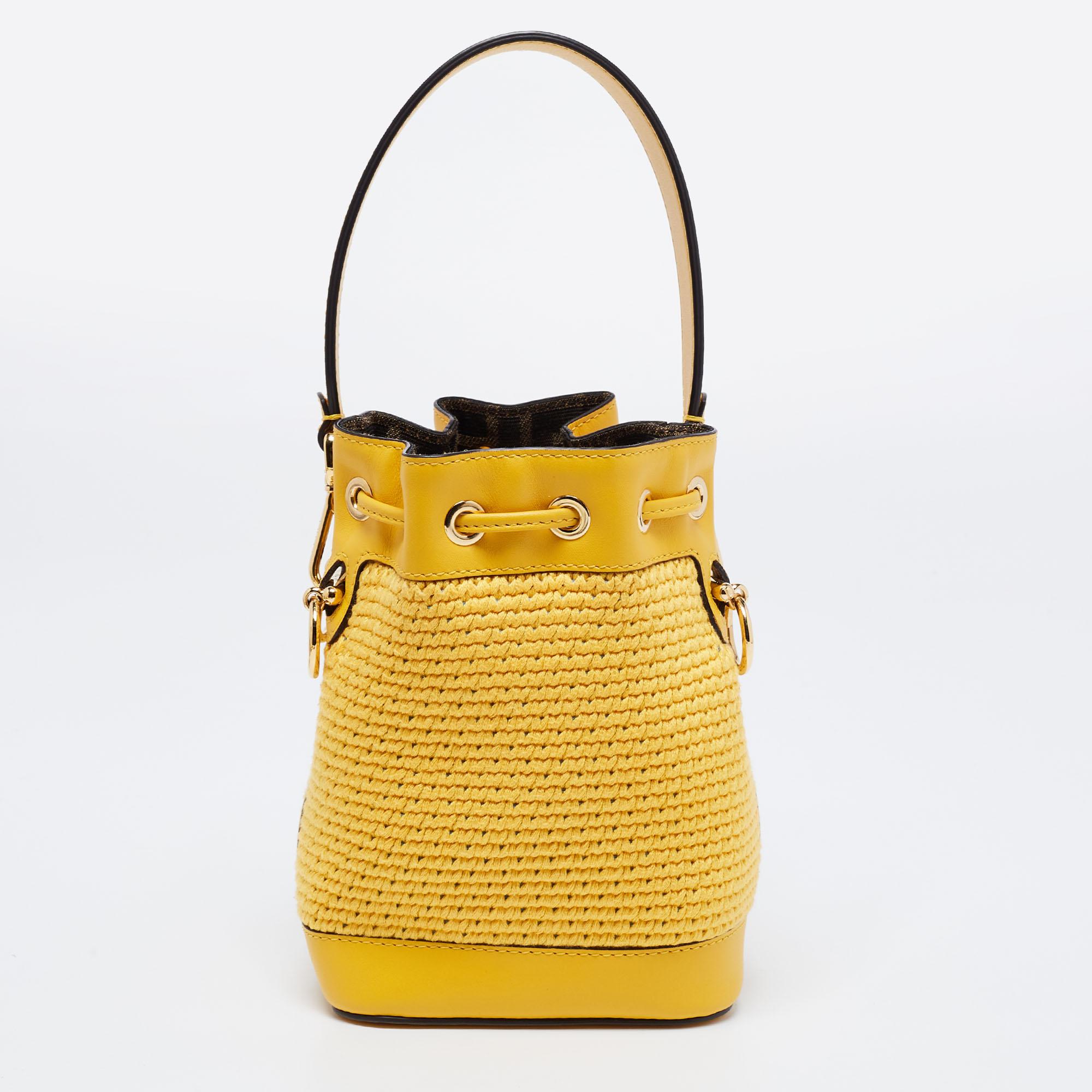 This wonderful Fendi design is made from crochet, leather, and gold-tone hardware. The bag has a bucket shape with a drawstring closure that secures the well-sized interior. Complete with a top handle and a shoulder strap, it is an apt accessory to