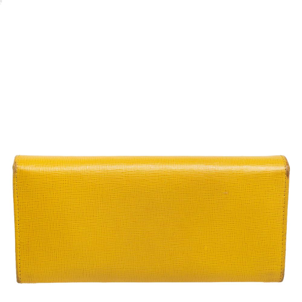 Made using yellow leather, this continental wallet from Fendi has a simple look and functional quality. The flap opens to a sleek interior featuring a zip pocket, open compartments, and card slots.