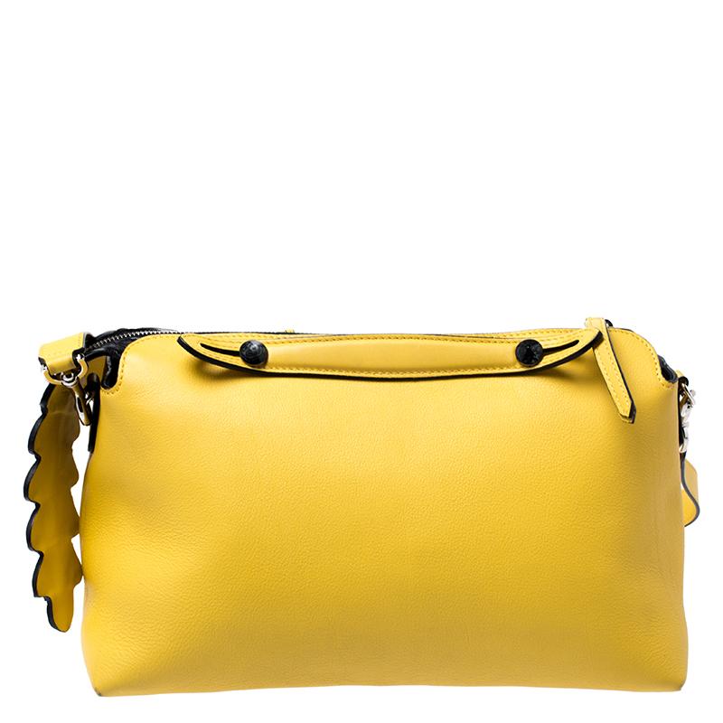 A new design from Fendi, this By the Way Boston bag is made from yellow leather. Complemented by silver-tone hardware, it has a removable shoulder strap. Its main compartment has room for the essentials and is secured by a zip detail. It is complete
