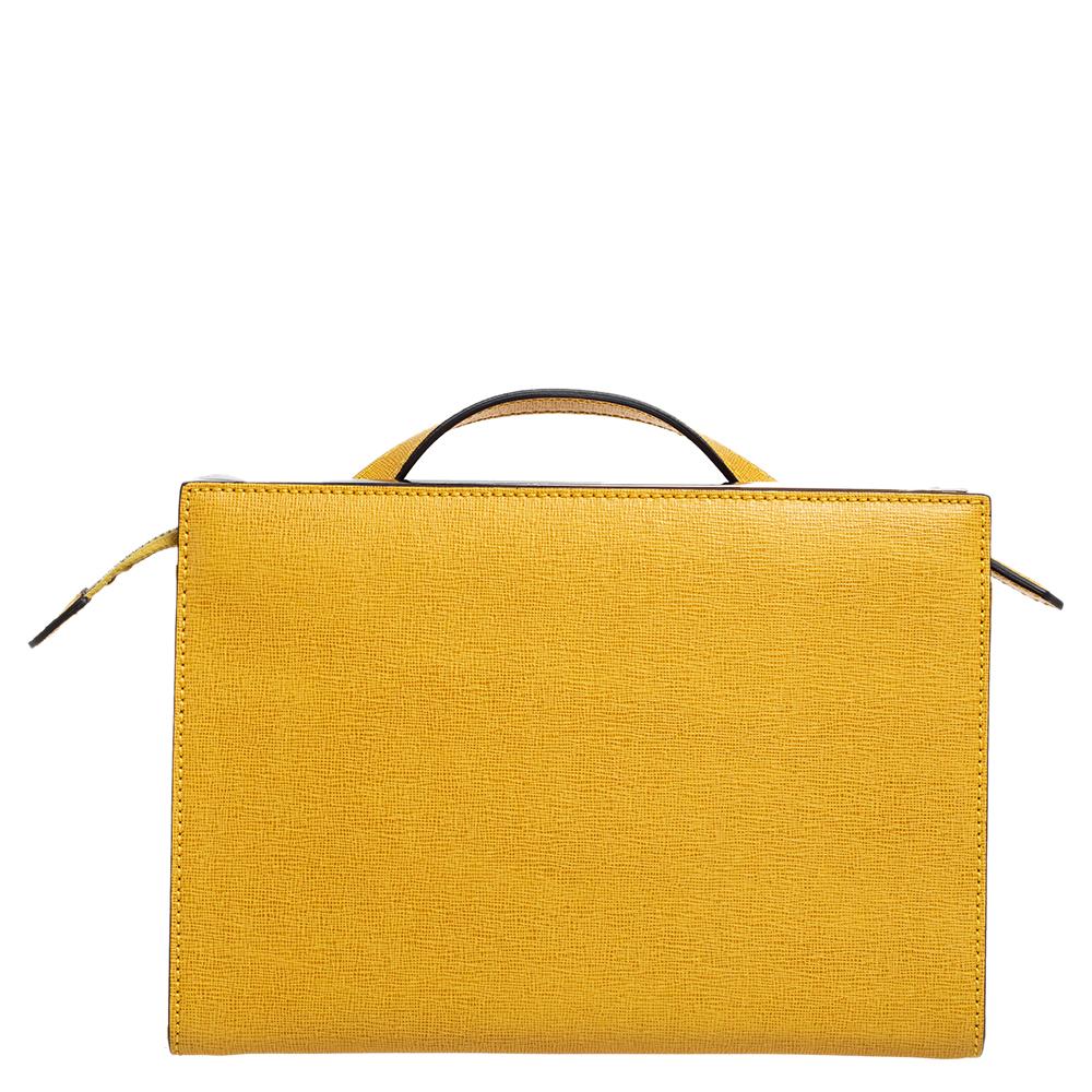 This Demi Jour bag by Fendi is not only lovely to look at, but is also handy and durable. It has been crafted from yellow textured leather and styled very artistically with a flap compartment in the front and a zipper one at the back. The insides