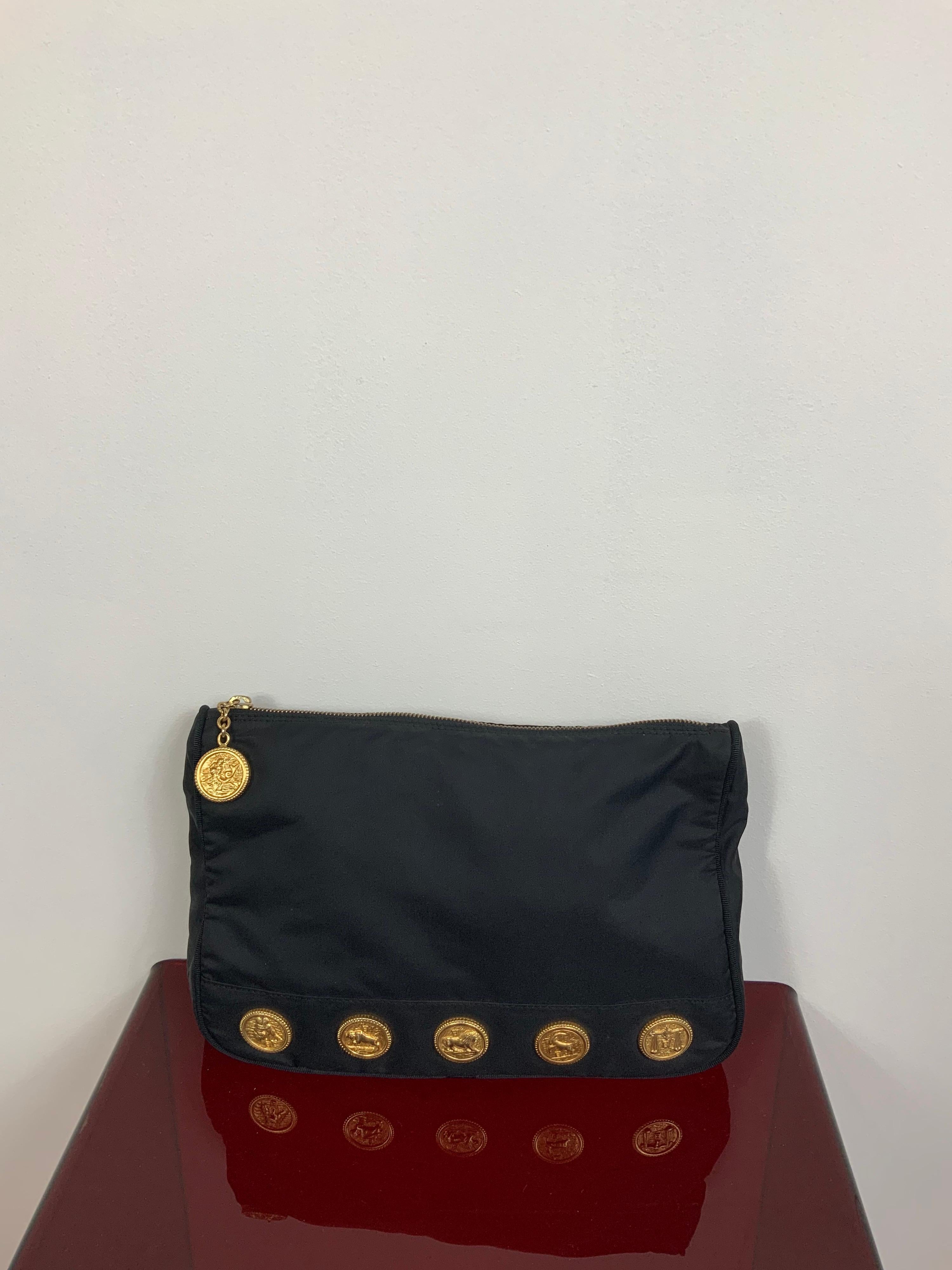 Fendi vintage bag.
Featuring Zodiac gold medallion and black nylon fabric.
Zip Closure. Leather as bag interior. One interior pocket. 
Measurements:
Height 20 cm
Width 30 cm
Depth 5 cm
Conditions: Good - Previously owned and gently worn, with little