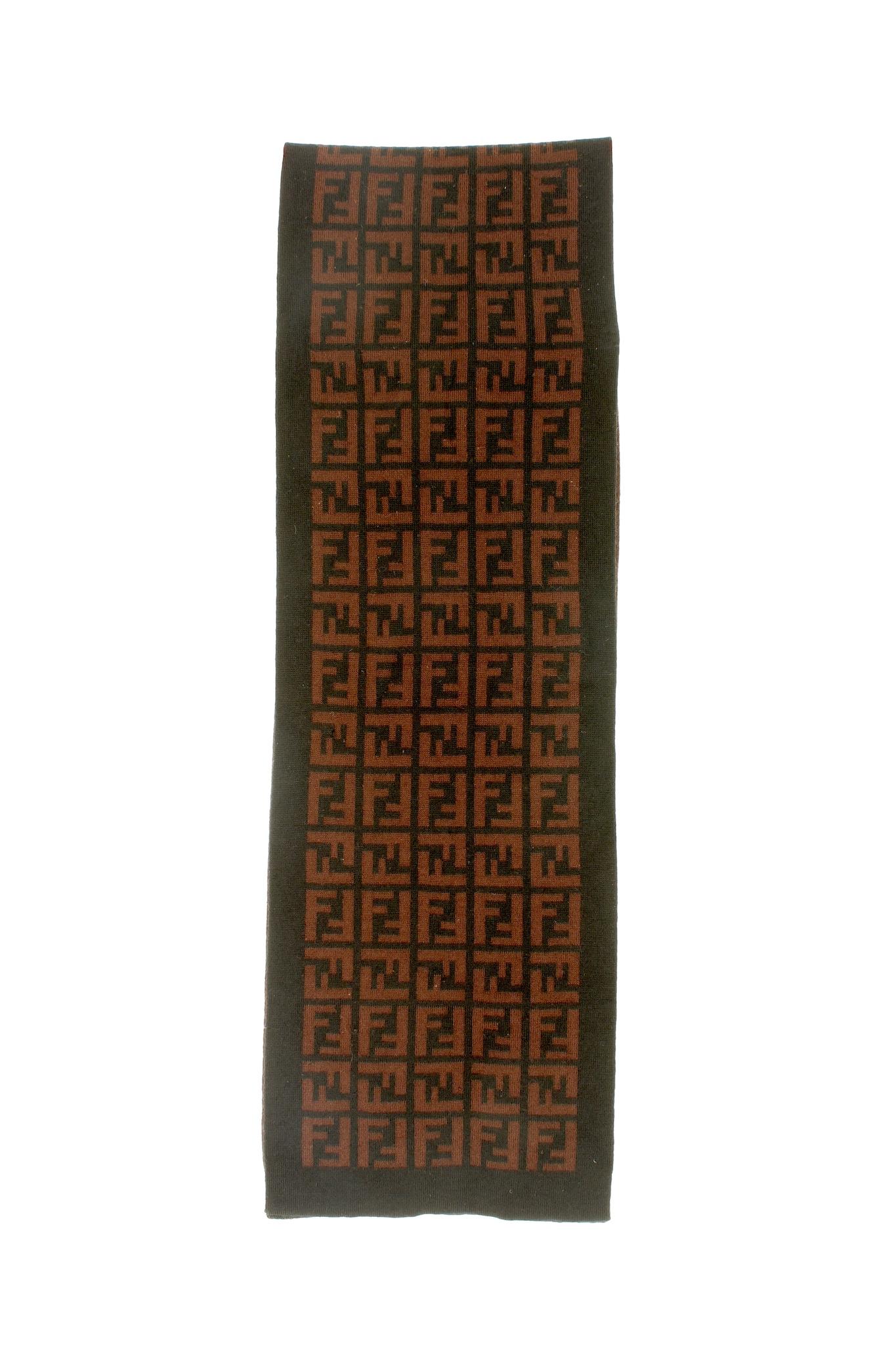 Fendi pumpkin vintage scarf from the 2000s. Monogram pattern in brown and black. 100% wool fabric. Made in Italy. The scarf is overall in excellent condition, there is a small hole on the edge. 

Measures: 157 x 26 cm