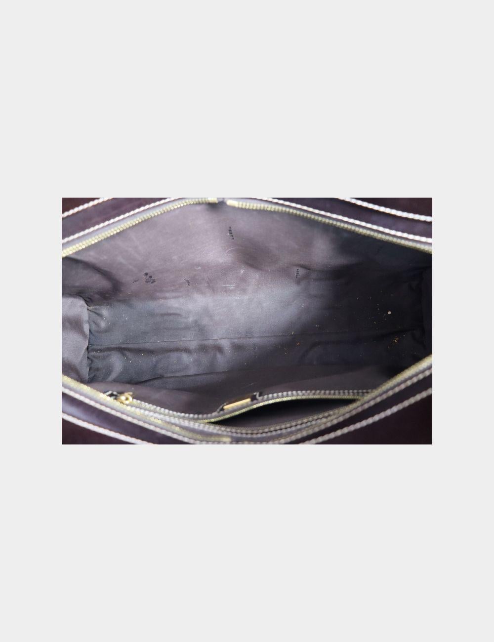 Turn heads with this bold and iconic Fendi studded handbag, crafted in signature Zucca monogram canvas and rich brown leather. Embellished with gold-tone studs and structured leather trim, this piece blends vintage luxury with a rock-chic