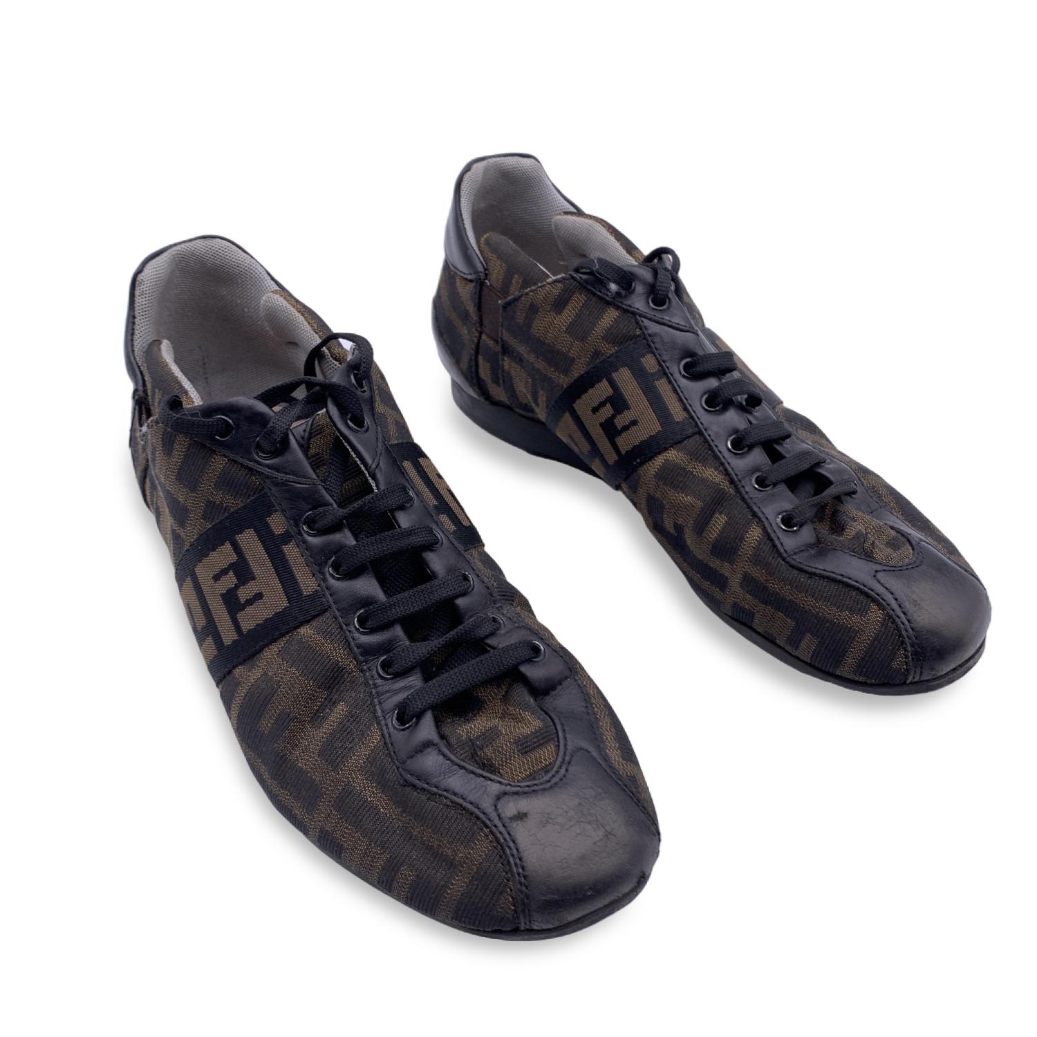 Fendi Tobacco Zucca Monogram Sneakers.  Zucca printed canvas with black leather trim. Lace up fronts and rounded toes. The insoles are lined with fabric. Rubber outsoles. Size 37

B - VERY GOOD
Some scratches on leather trim. Some wrinkles on the