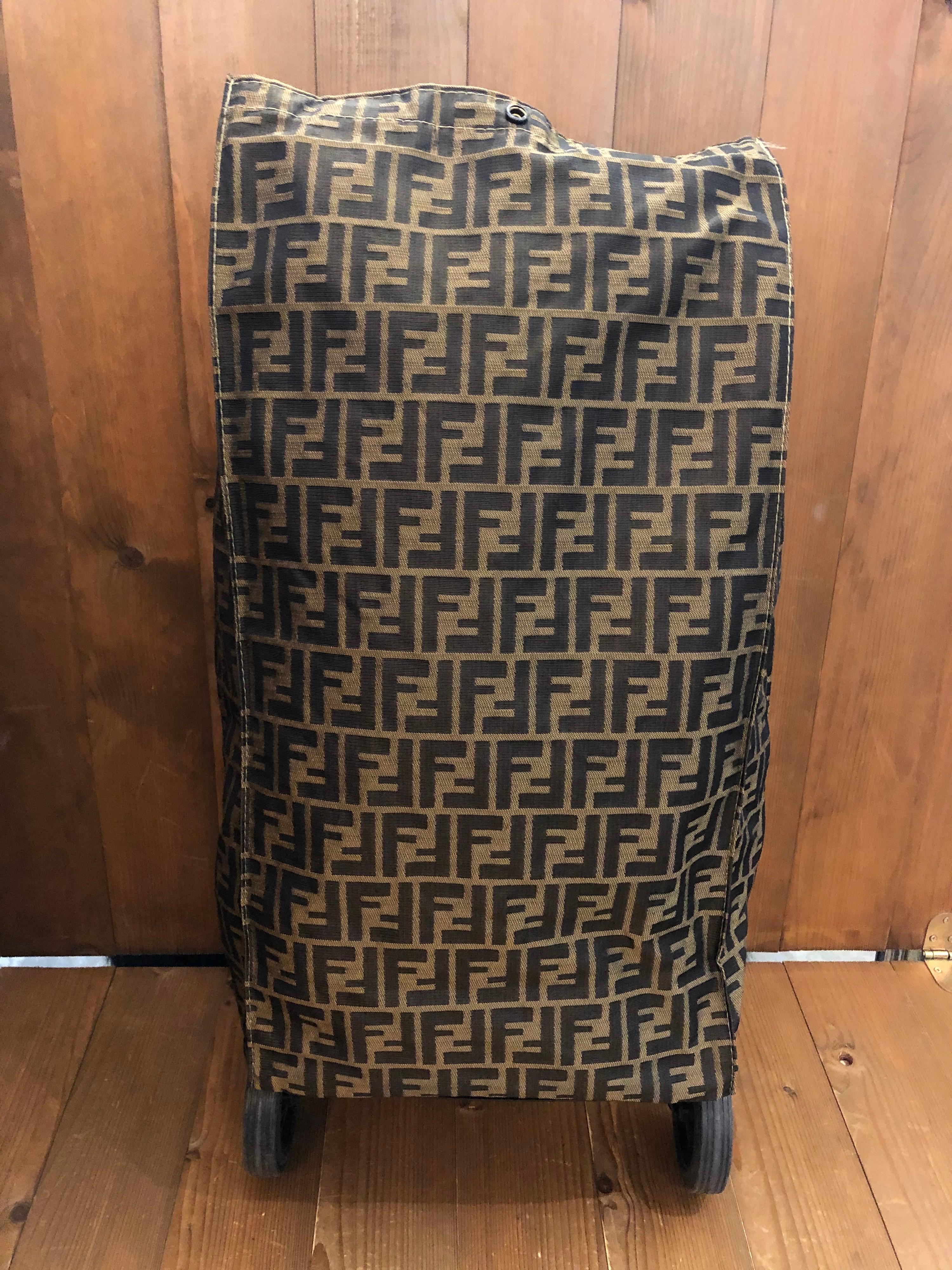 Fendi Rolling Luggage Trolley Bag in iconic brown Zucca jacquard. Foldable for easy storage. Made in Italy. Measures 30 x 19 x 60 cm Drop 18 cm. 

Condition: Minor signs of wear. Generally in good condition.