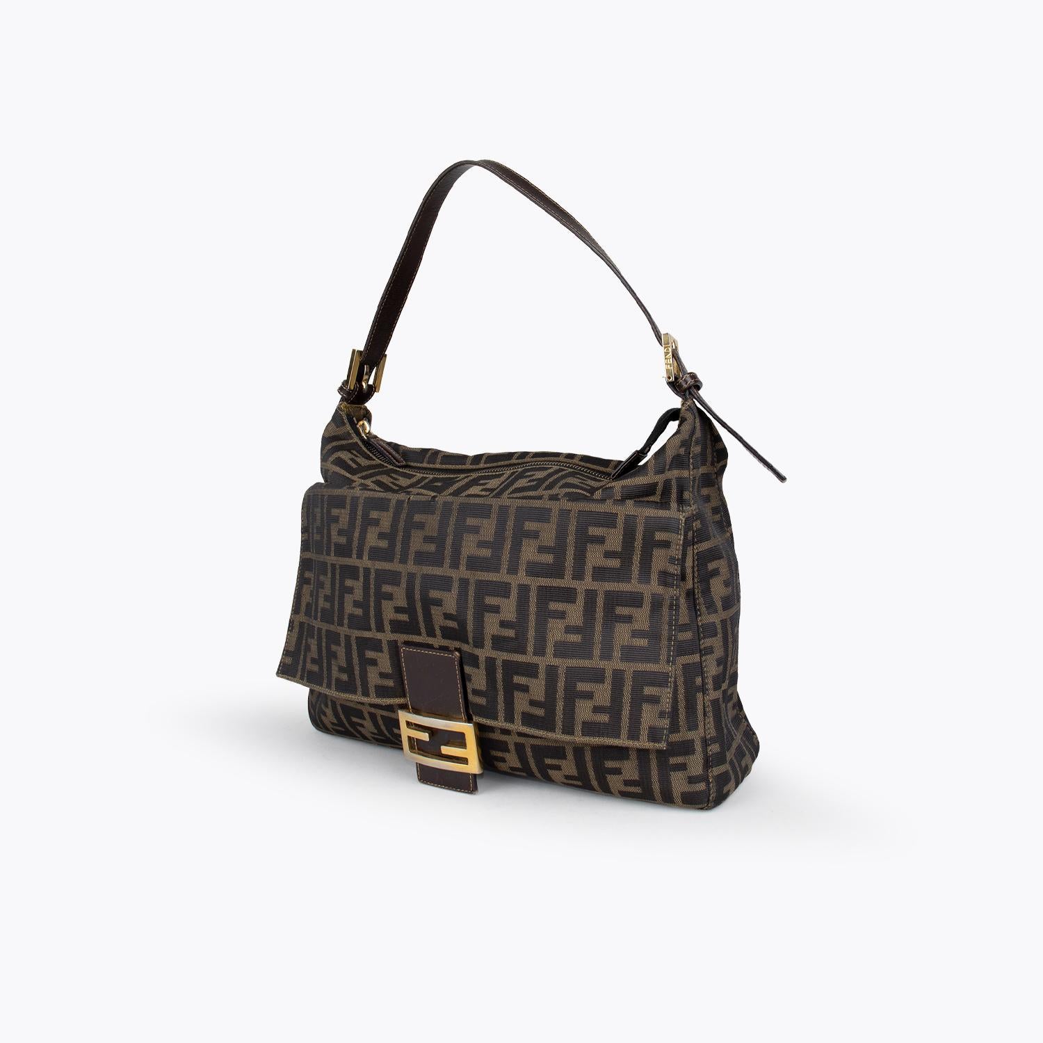Fendi Zucca Mama Forever Baguette Bag

– Gold-tone hardware
– Brown leather trim
– Adjustable shoulder strap
– Canvas Lining & single Interior Pocket with snap closure at front

Overall Preloved Condition: Very Good 
Exterior Condition: Very Good.