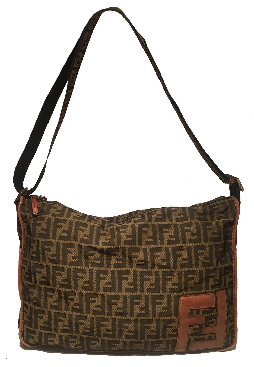 Fendi Zucca Monogram Messenger Bag in excellent condition. Signature zucca print monogram canvas exterior trimmed with brown leather. Woven nylon zucca monogram adjustable shoulder strap. Top double zipper closure opens to a dark grey woven nylon