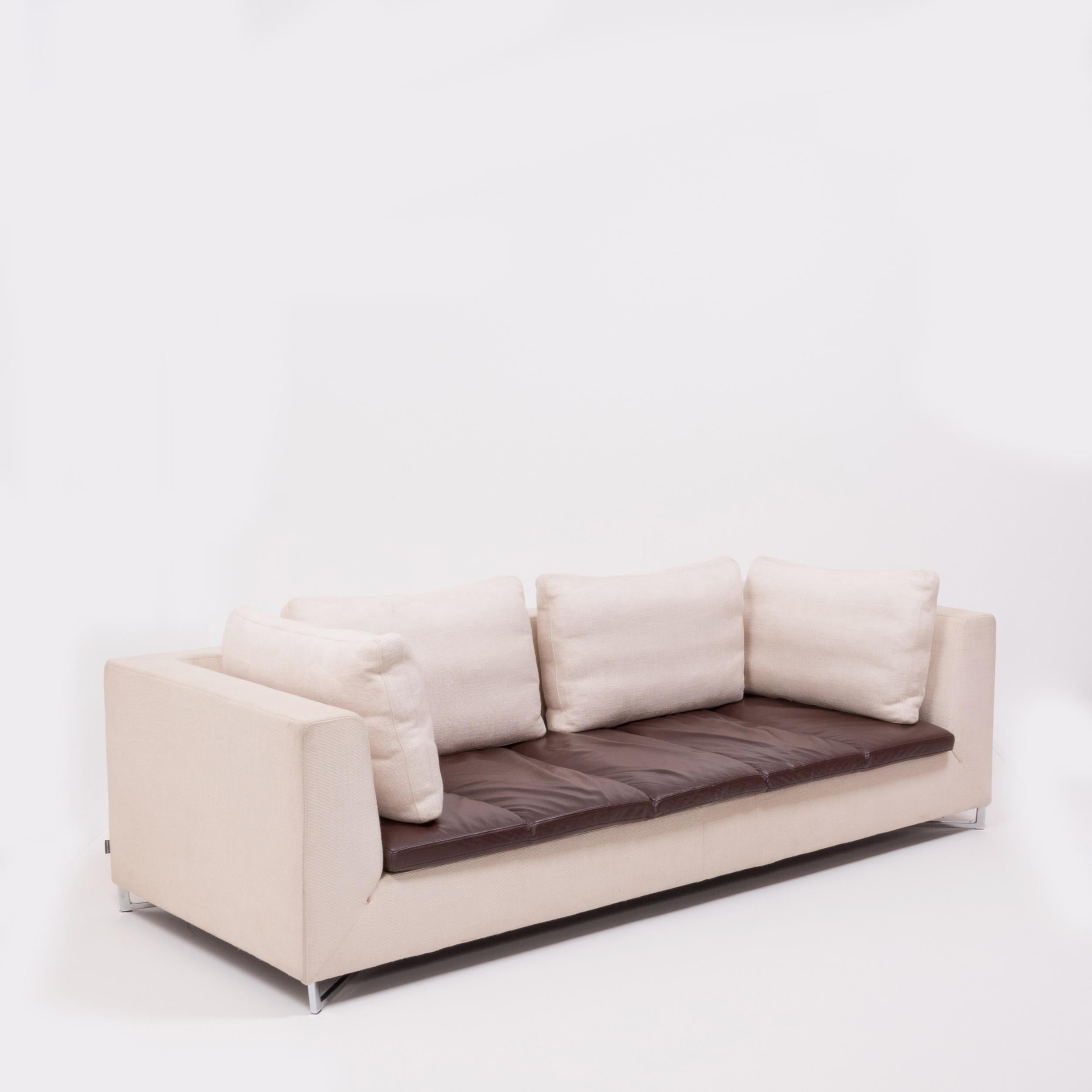 Designed by Didier Gomez for Ligne Roset, this Feng three-seat sofa combines modern elegance with ultimate comfort.

The sturdy frame is upholstered in ivory woven fabric and sits on an angular chrome base. 

The fabric is contrasted by the
