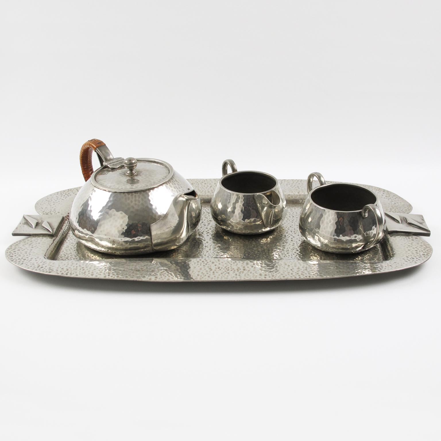 Refine English Art Nouveau polished pewter tea or coffee serving set with tray by Fenton Bros Ltd, Sheffield. Set includes coffee or teapot with straw handle, sugar bowl, creamer, and large serving tray. The set is stamped underside of each piece: