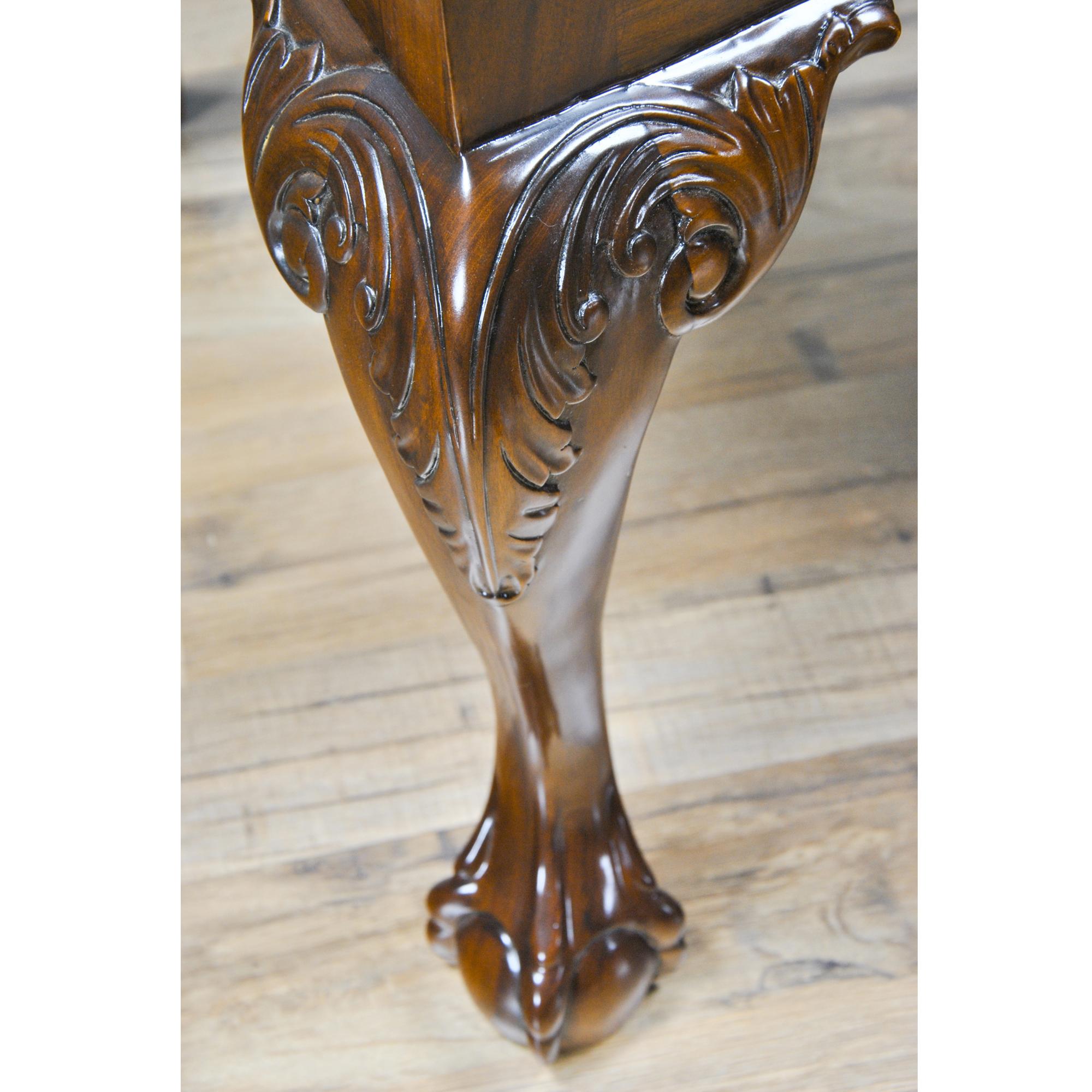 The Fenton Mahogany Chairs features 2 arm chairs and 8 side chairs. The chair backs are fully decorated with carving rendered in solid mahogany while the vertical stiles of the chairs are reeded. The carved crest rail, located across the top of the