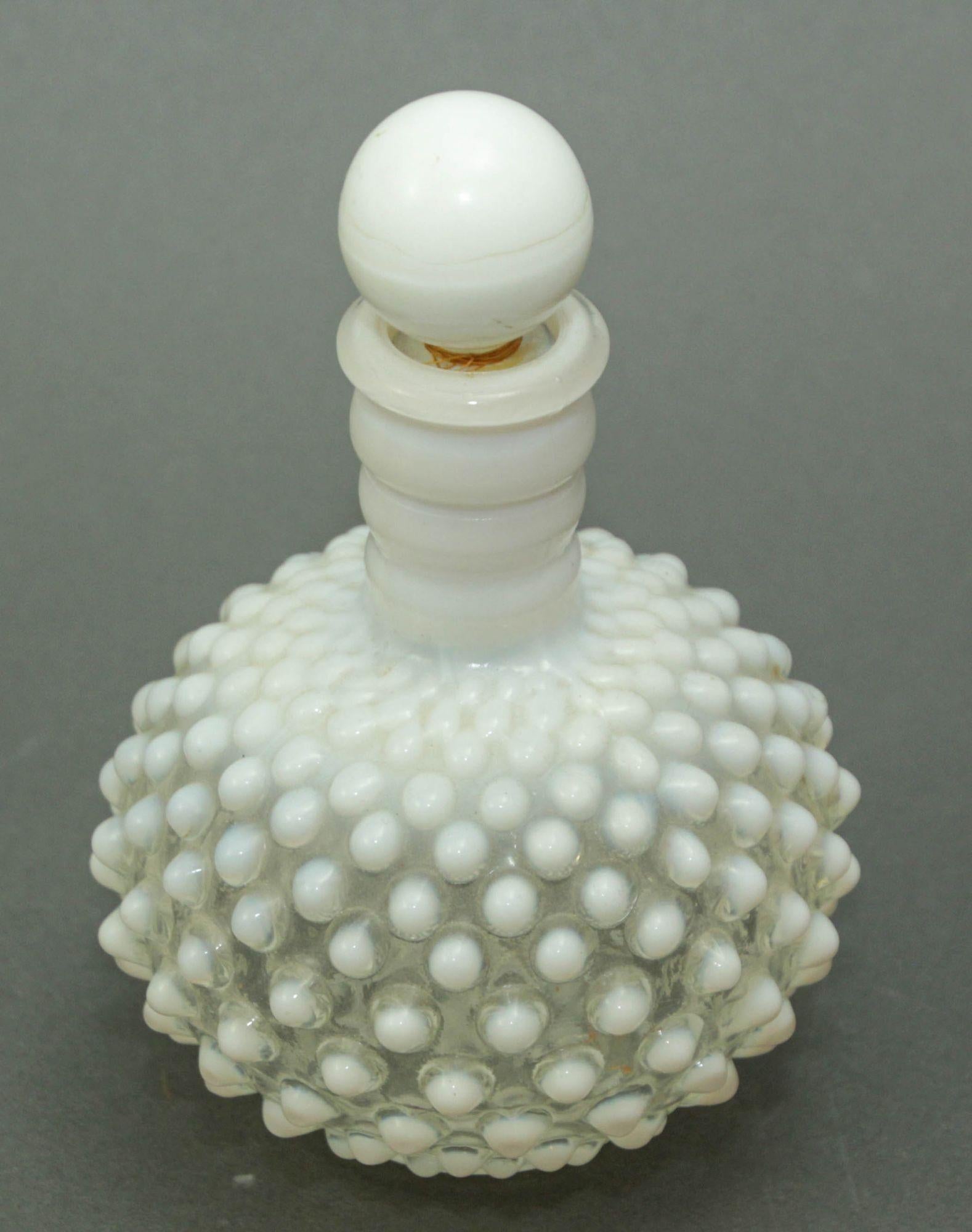 Fenton Wrisley Hobnail White Opalescent Glass Cologne Bottle With Stopper.
This charming vintage cologne bottle is made of glass. This beautiful piece of glass is made in the style of Fenton Glass bottles made for Wrisley cologne.
Fenton perfume