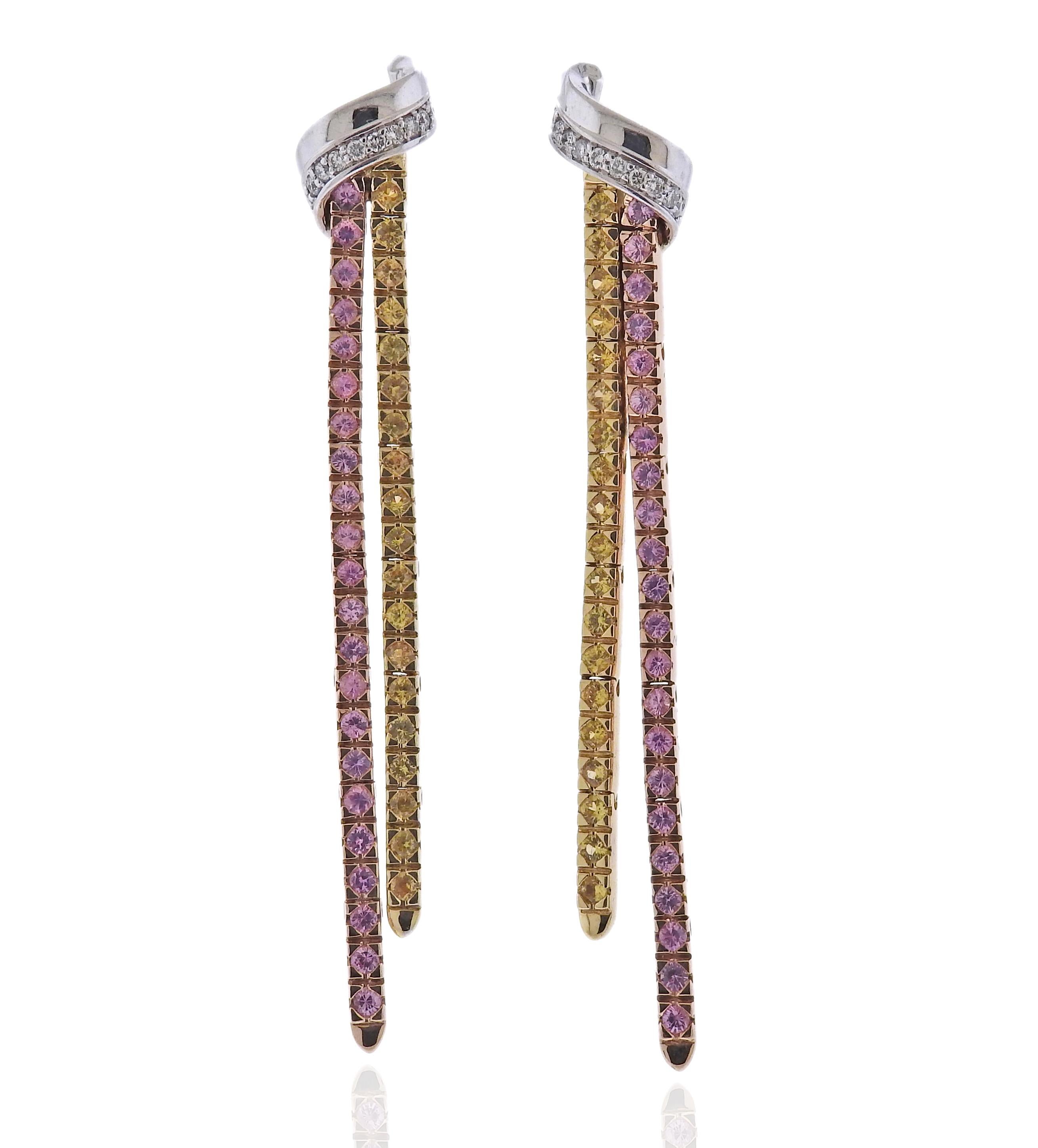 18k gold Feraud earrings with pink sapphires and approx. 0.20ctw in diamonds. Earrings are 63mm x 10mm, missing backs. Weight 12.4 grams. Marked: 18kt. Feraud. 