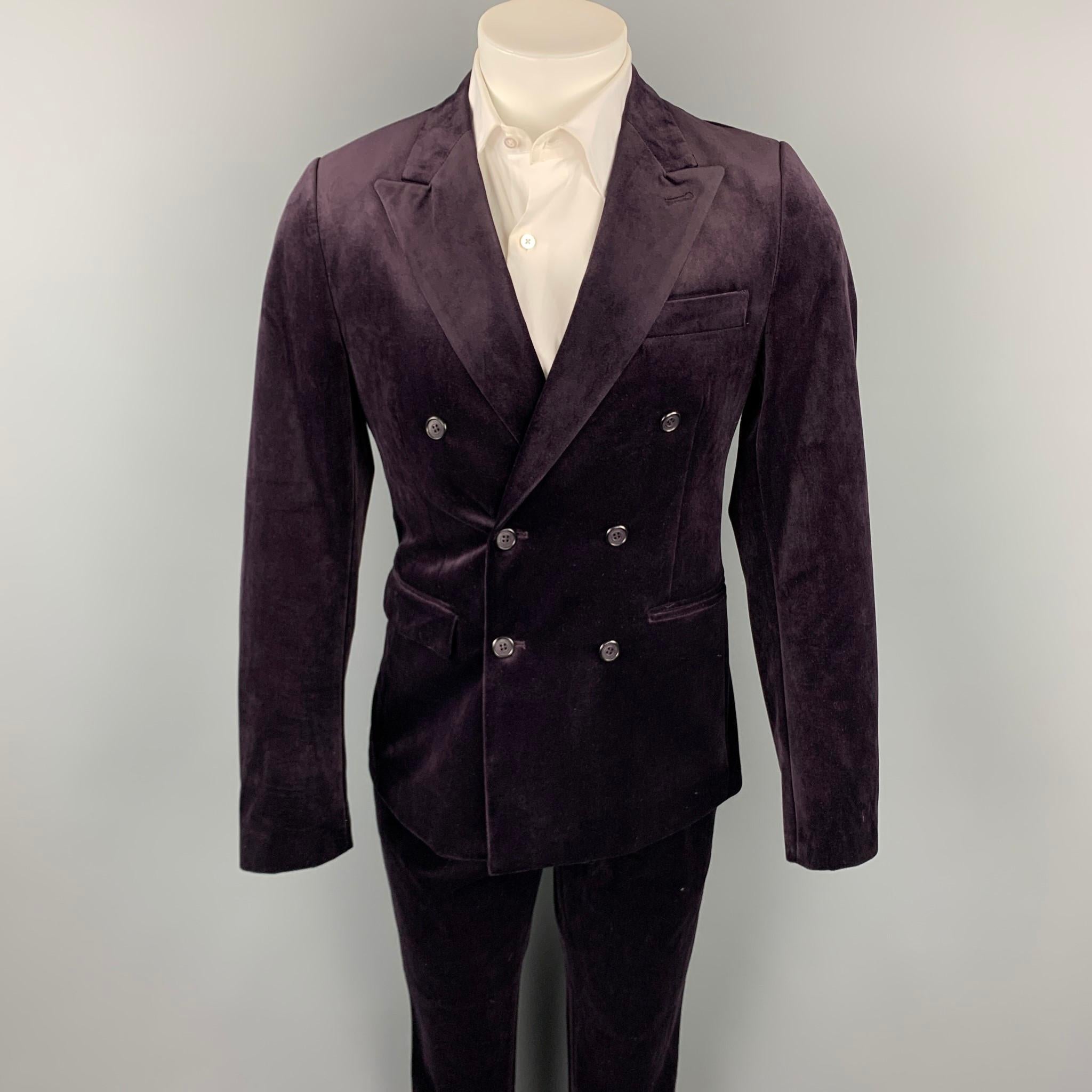 FERAUD suit comes in a purple polyester with a full liner and includes a double breasted button sport coat with a peak lapel and matching flat front trousers.

Very Good Pre-Owned Condition.
Marked: 38

Measurements:

-Jacket
Shoulder: 16.5
