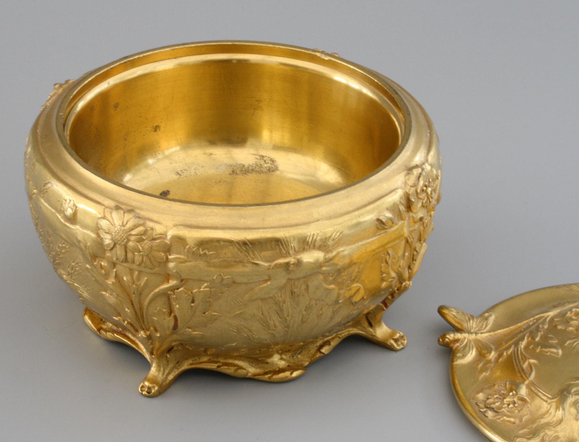 A stunning quality Art Nouveau French richly gilded bronze lidded box designed by C Robinet for Ferdinand Barbedienne (1810-1892) and dating from the latter 19th century. The rounded box stands raised on four paw shaped feet and scroll base edge