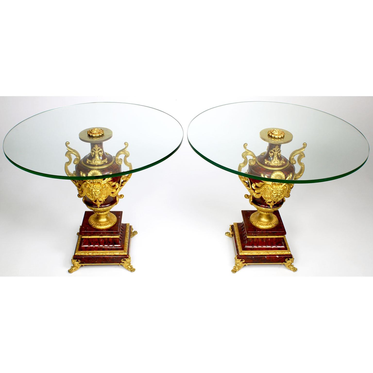 A fine pair of French Louis XV style Ormolu Mounted Rouge Griotte marble urns by Ferdinand Barbedienne (French, 1810-1892), now converted to low side tables with glass tops. The ovoid shaped urns surmounted with finely chased allegorical ormolu male