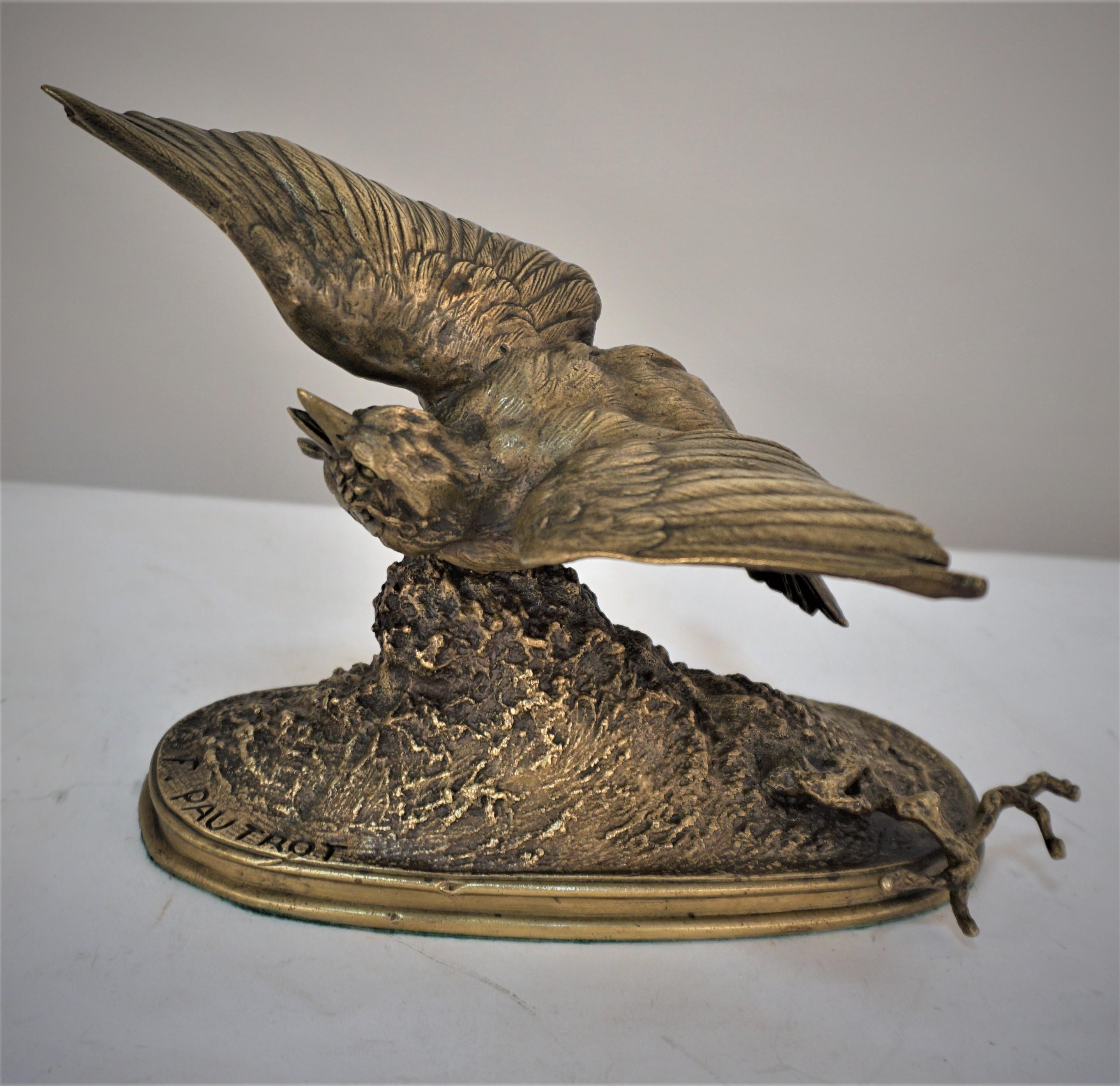 19th century brown-gold patinated bronze sculpture of bird on a tree stump.