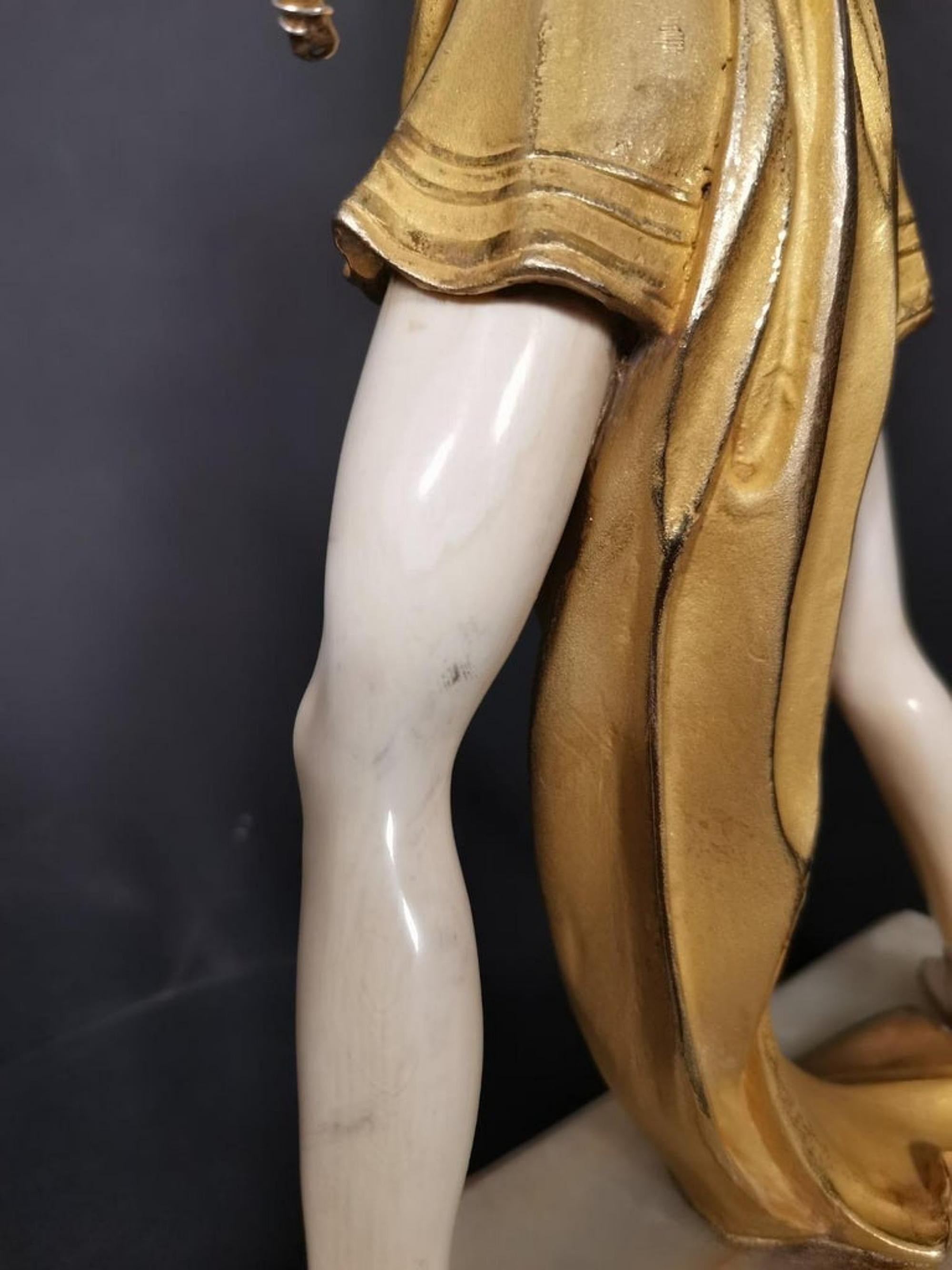 Ferdinand Preiss, Diana, 
An Art Deco figurine in gilded bronze and chryselephantine ivory,
Model 1081, around the 20th century,
Cast and modeled as an Archer in a tunic on an onyx base, mark incised at the base f preiss,
Measure: 35cm