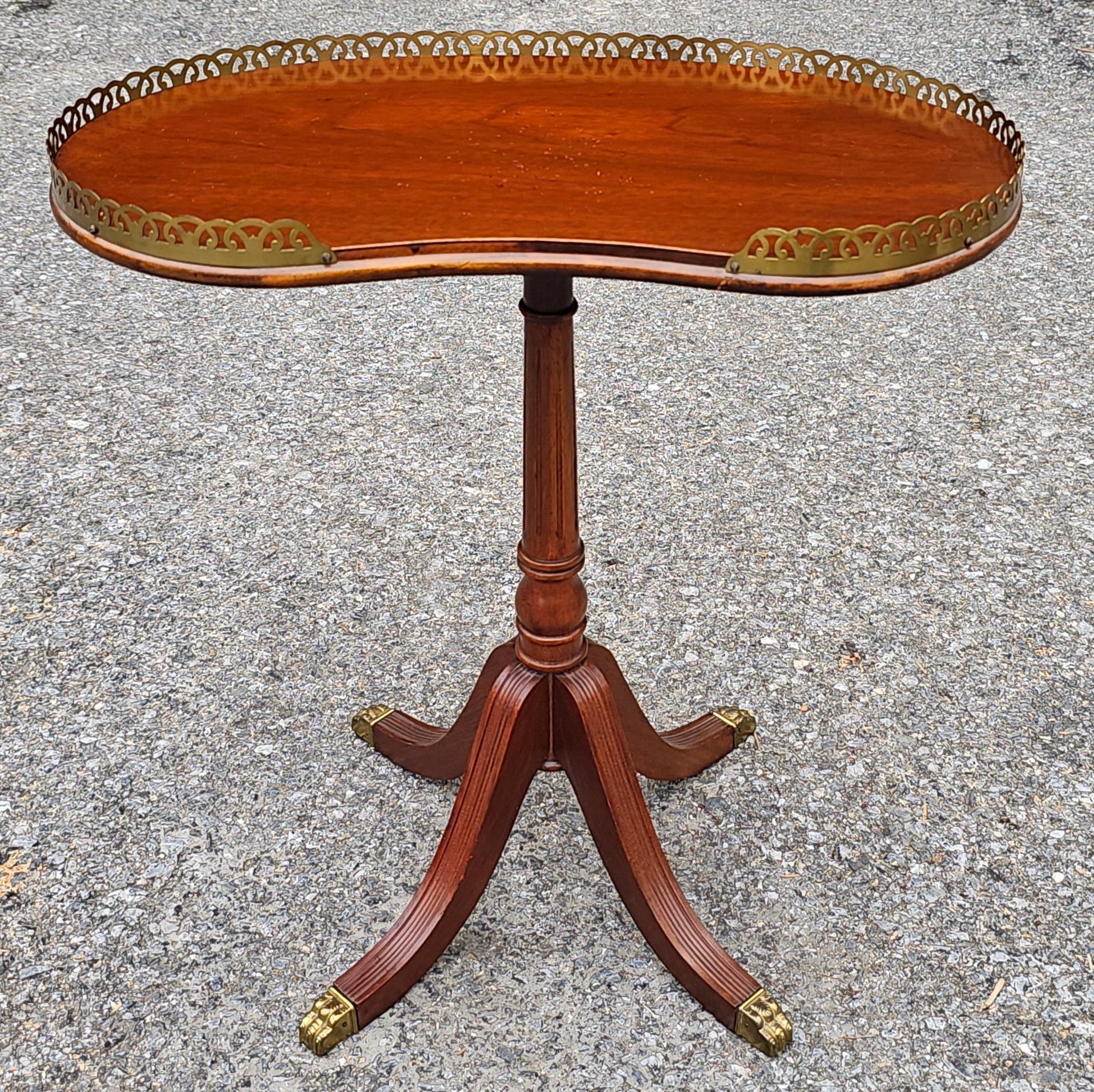 A Mid Century Ferguson Bros. Duncan Phyfe regency Style Mahogany Galleried Kidney Form , , quadpad pedestal with brass cap paw feet Candle Stand 
Measures 20