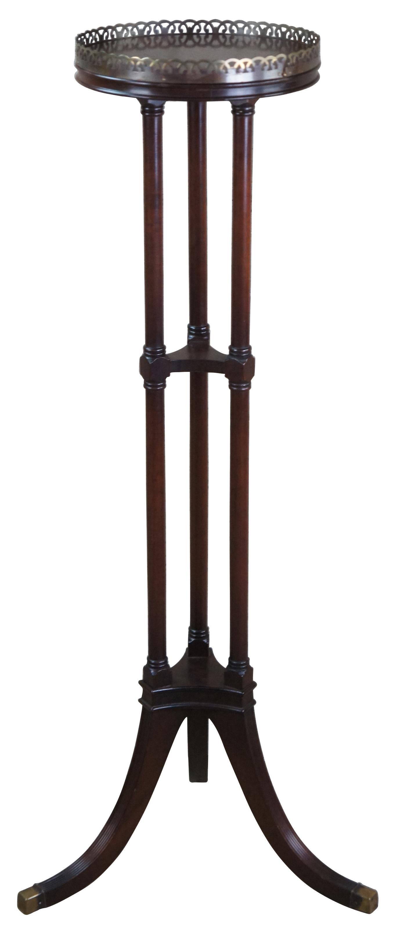 Antique Ferguson Bros Mfg Co pedestal table or plant stand. Made of mahogany featuring a tiered design with flared fluted legs, three turned columns and brass gallery.

Ferguson Brothers Manufacturing Company (founded 1878 in New York City) was
