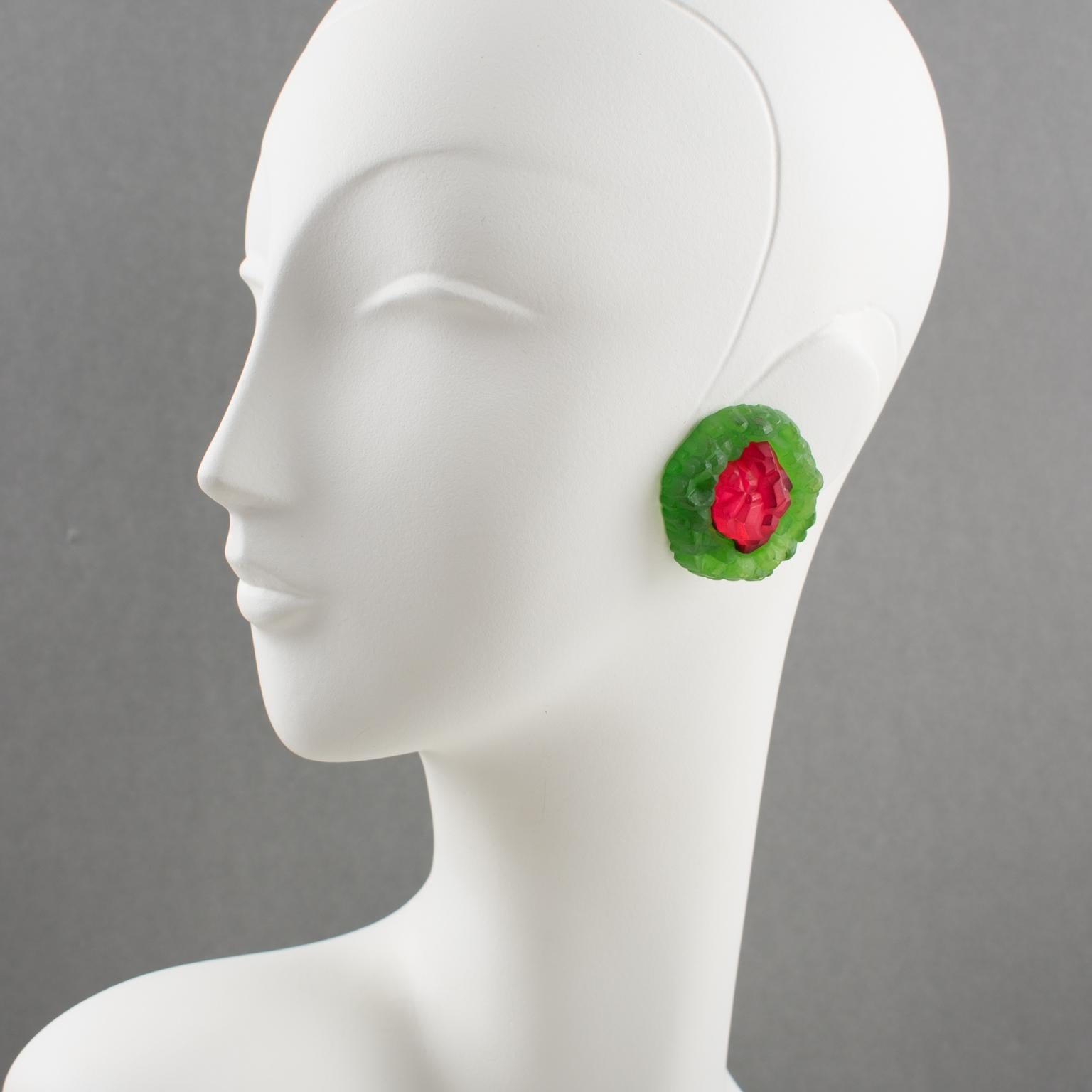 These stunning oversized carved Lucite clip-on earrings are from an Italian design studio. They feature a dimensional, rounded shape with rock carving in luminous ruby red and fern green colors and a frosted textured pattern. Expect a very unusual