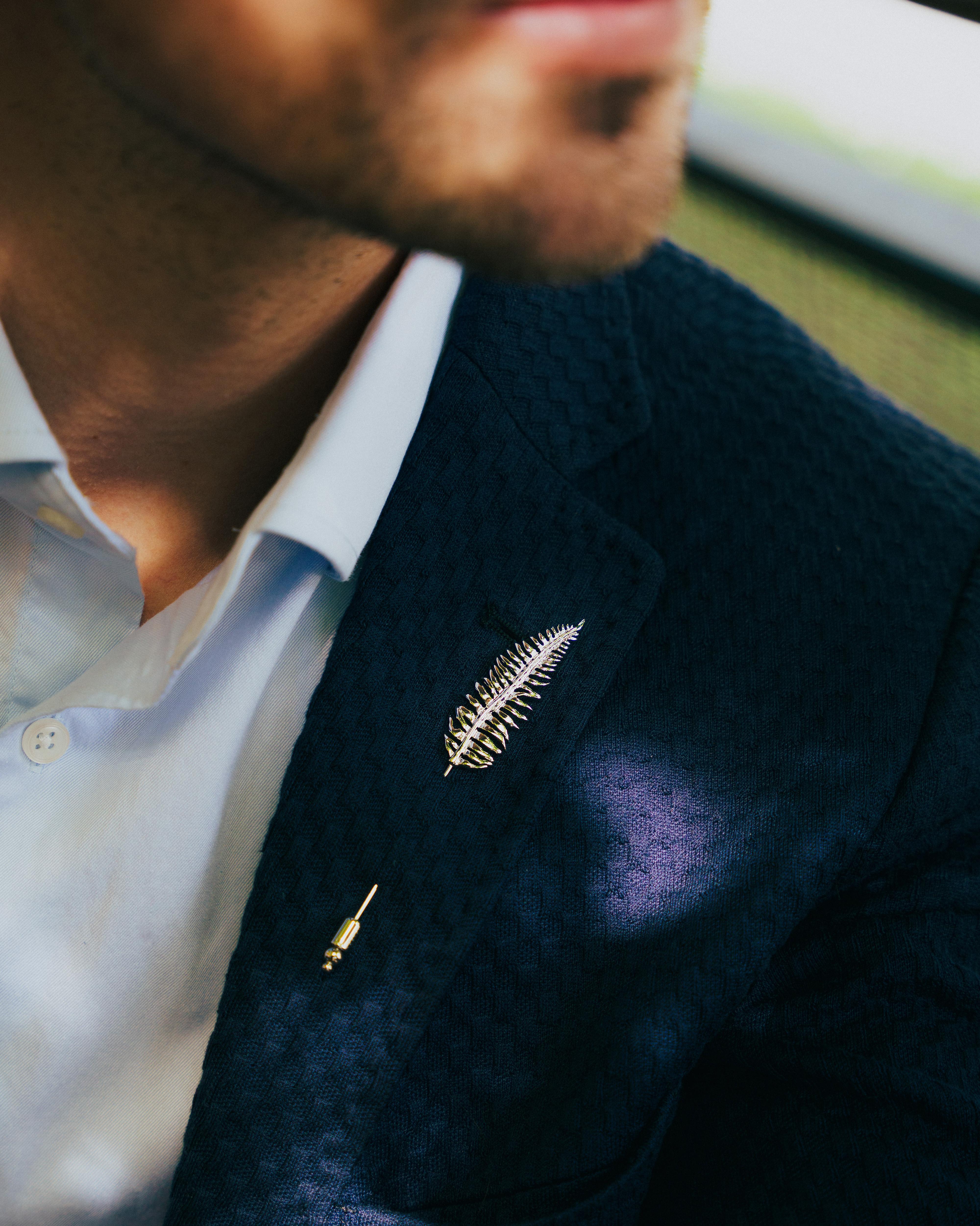 Fern lapel pin with rhodium finish

Conveying the texture and shape of a fern leaf set in rhodium plated base metal. A highly-polished finish creates a surface which catches the natural light and leaves your suit refreshed with a subtle shine. The