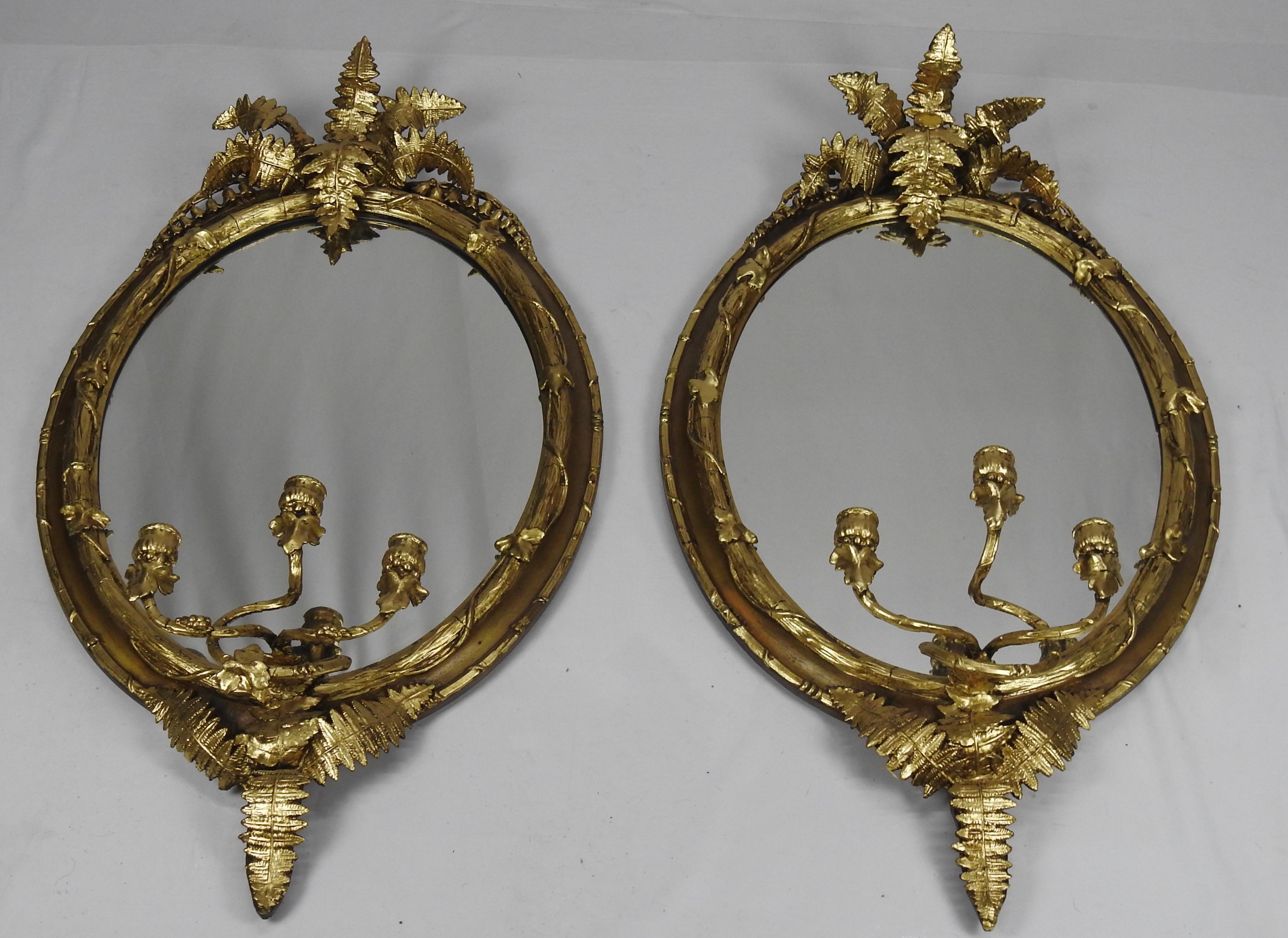 Offering this stunning pair of French fern leaf mirrors. Water gilt highlighting the fern leaf and candleholders.