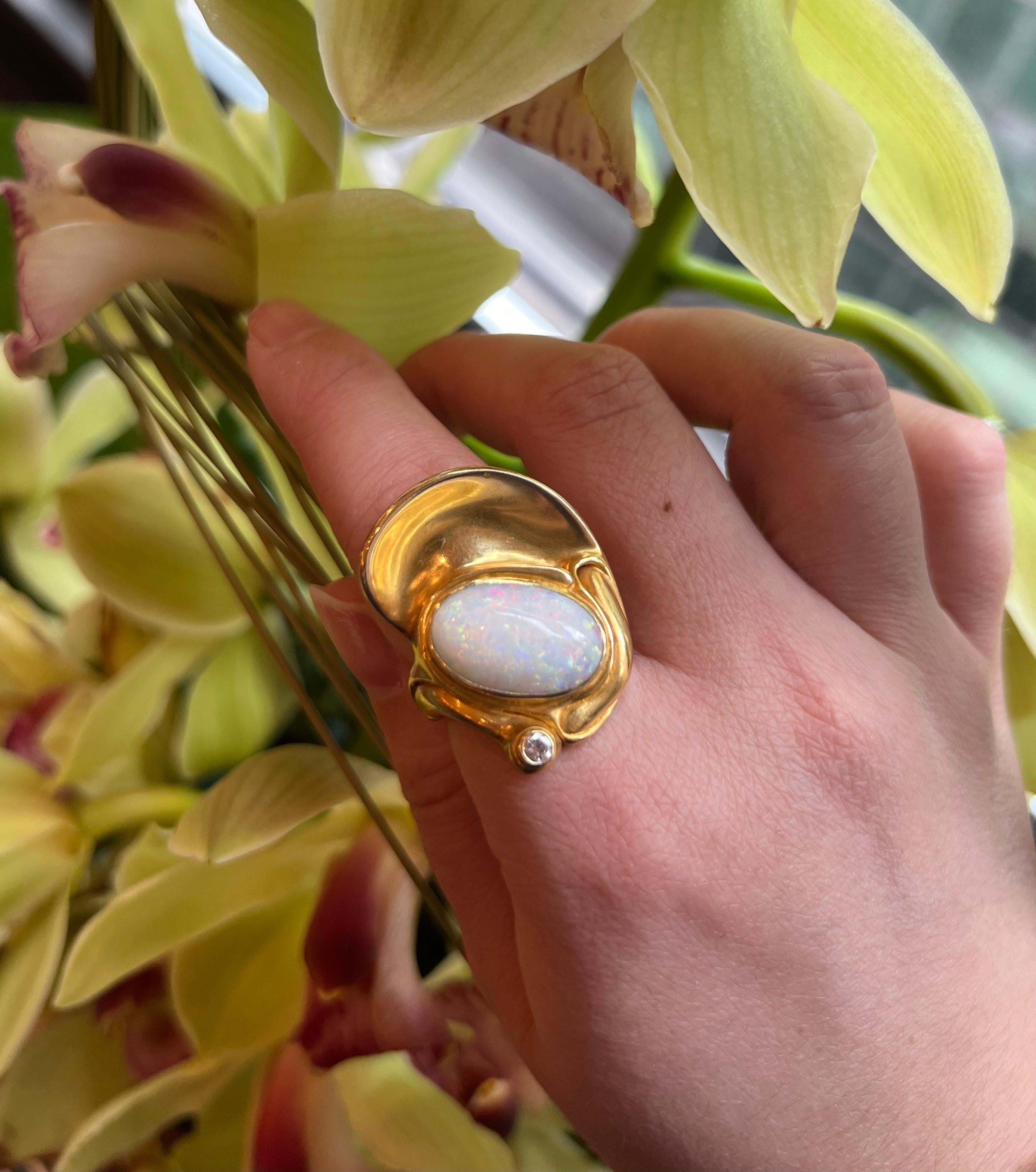 A unique white fire opal and diamond 18-karat yellow gold art jewel, this ring by Claude West, based at the famed Belgian jeweler Fernand Demaret, is Signed Demaret, 750, with the maker's mark. It is a ring size 7. This ring is not resizable.

In