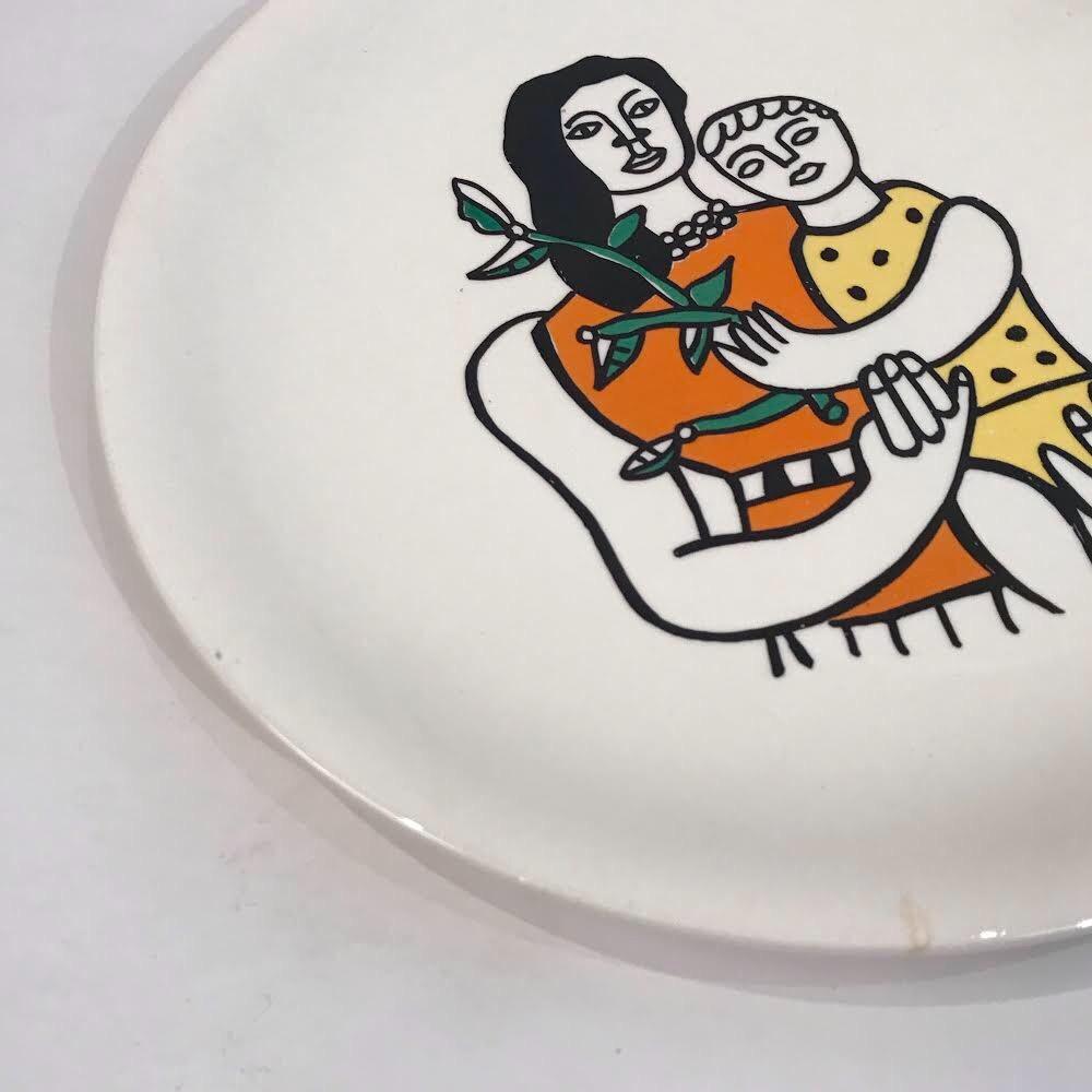 Plate with image after Fernand Leger featuring a mother and her child holding a plant.
 