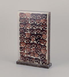 Fernandez Arman (1928–2005). Accumulation of burnt wood violin bridges in resin.