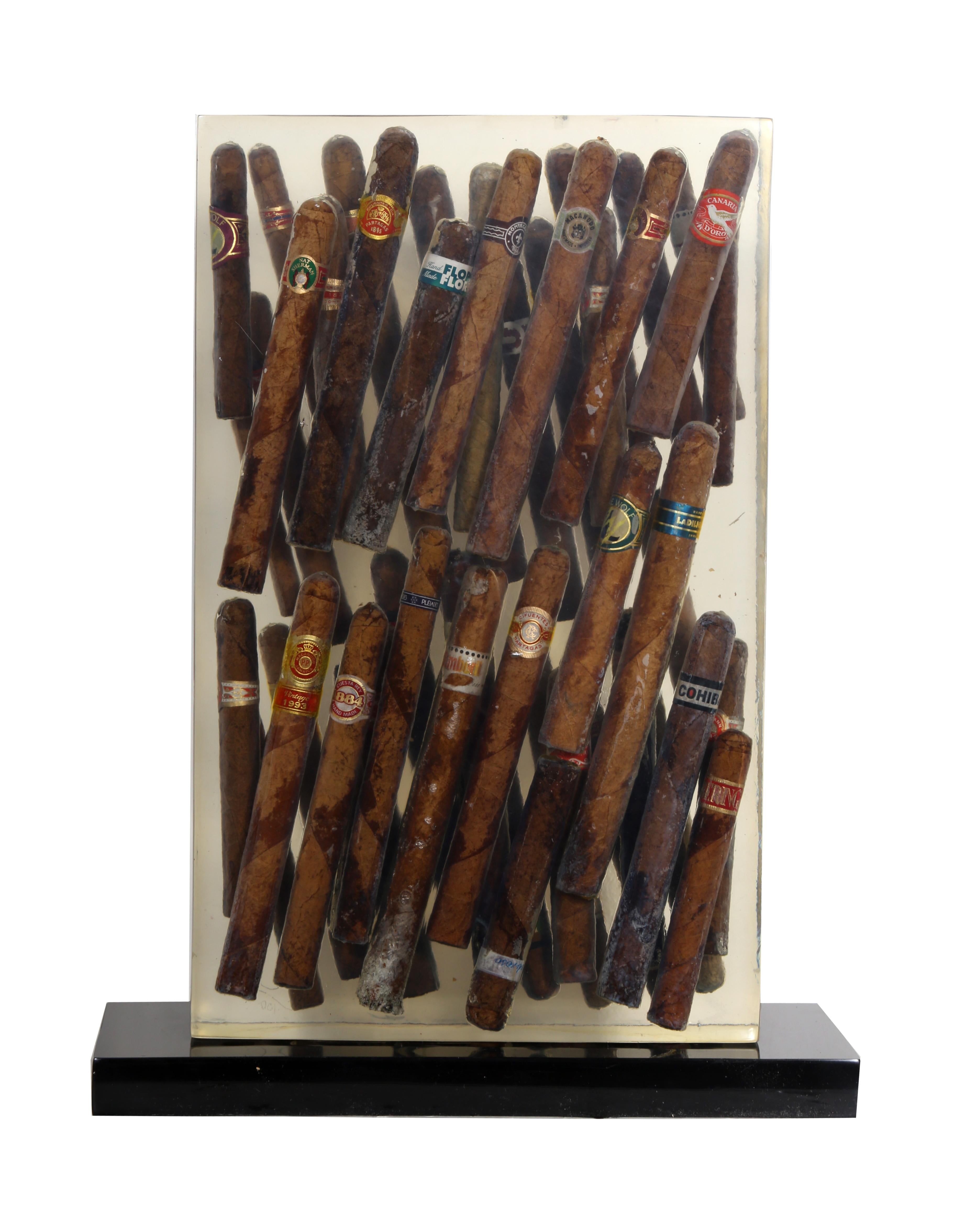 A unique sculpture by the French artist, Arman. This collection of world-class cigars encased in clear resin is a quintessential piece from Arman's 'Accumulations' period in which he took a group of everyday objects, usually mass-produced and