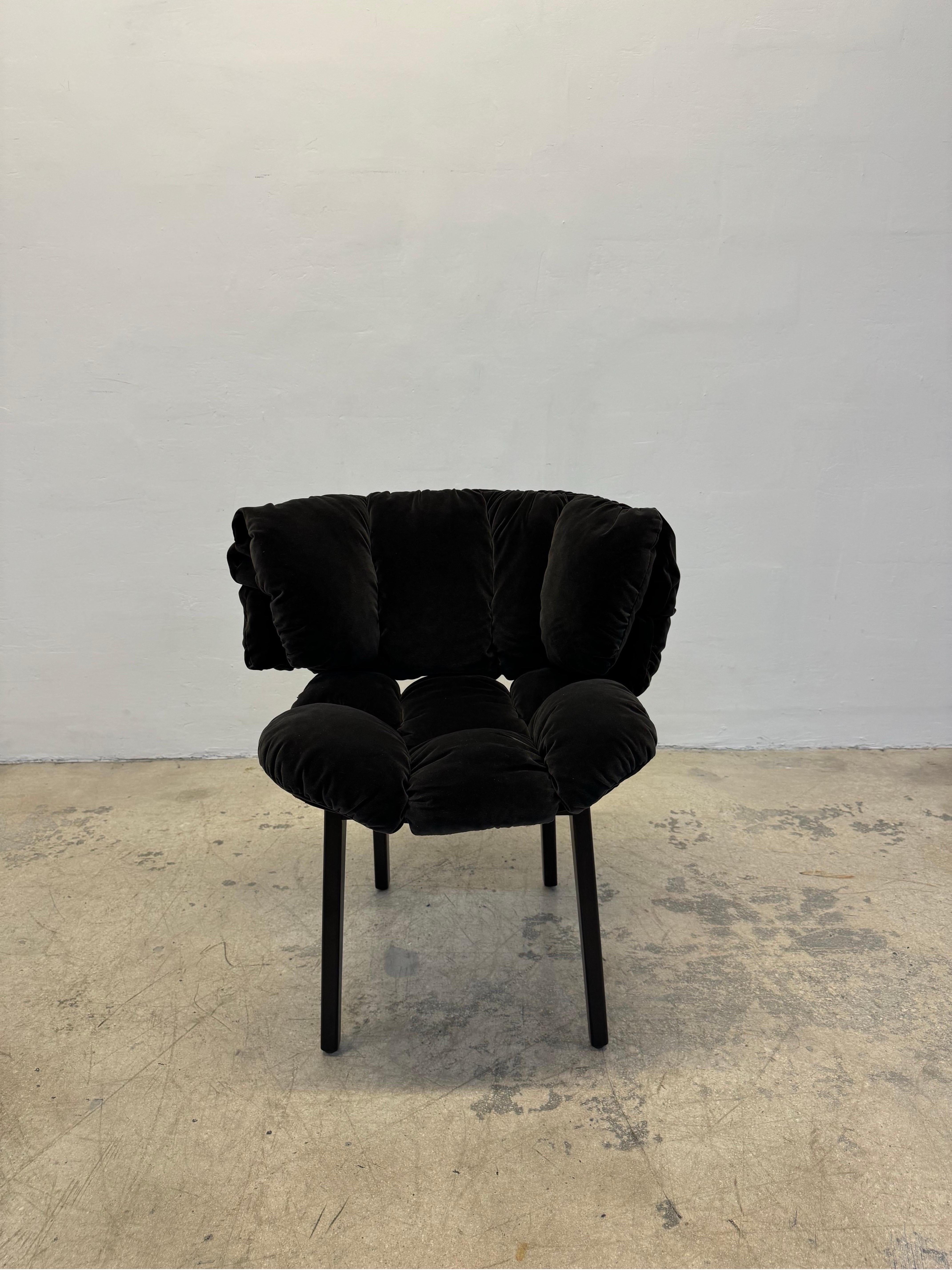 Blue Velvet chair rendered in a quilted charcoal gray cotton velvet fabric and supported by a dark wood frame. The Blue Velvet chair was designed by Fernando and Humberto Campana for Edra. Like a comforter, it is soft and enveloping, perfect for any