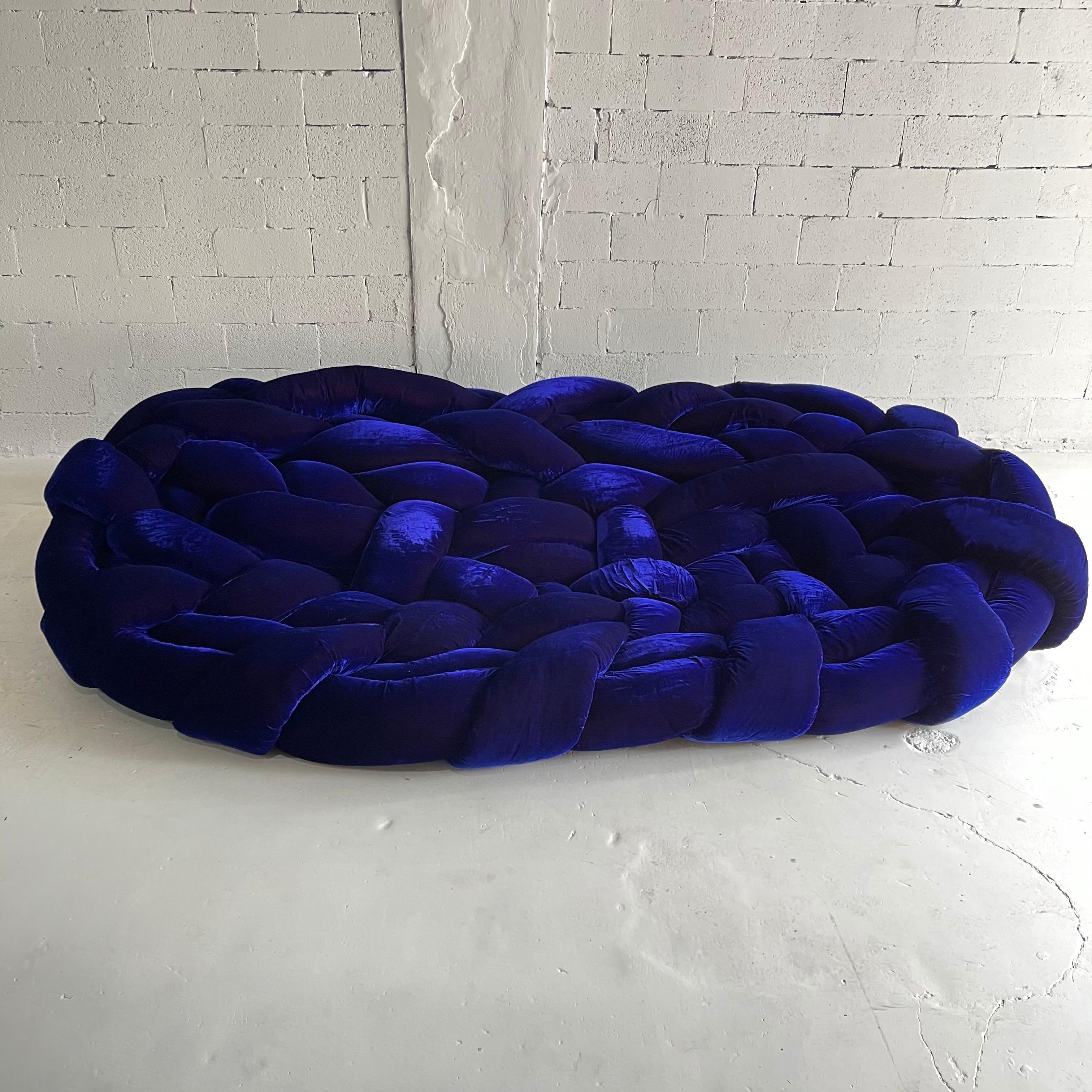 Excellent example of the creative talents of the Campana Bros. The Boa sofa, a woven nest constructed of 120 meters of polyurethane and goose feather tubing covered in a sumptuous iridescent Blue Violet velvet. The version is the largest size. A