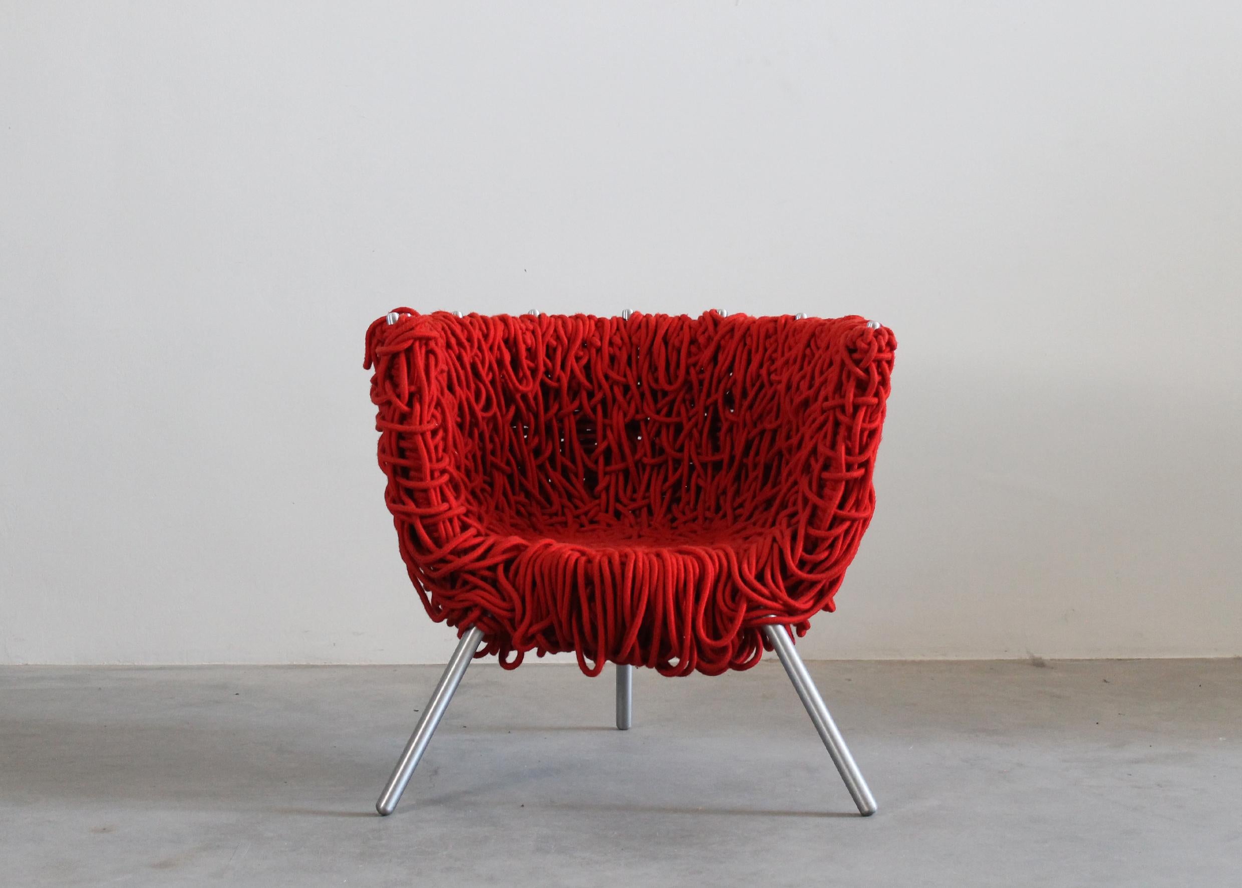 Vermelha armchair with epoxy powder painted steel frame and massive glazed aluminum legs, seating and back entirely realized with a brilliant red shade acrylic rope.
For recreating this armchair are necessary several days of manual work with high