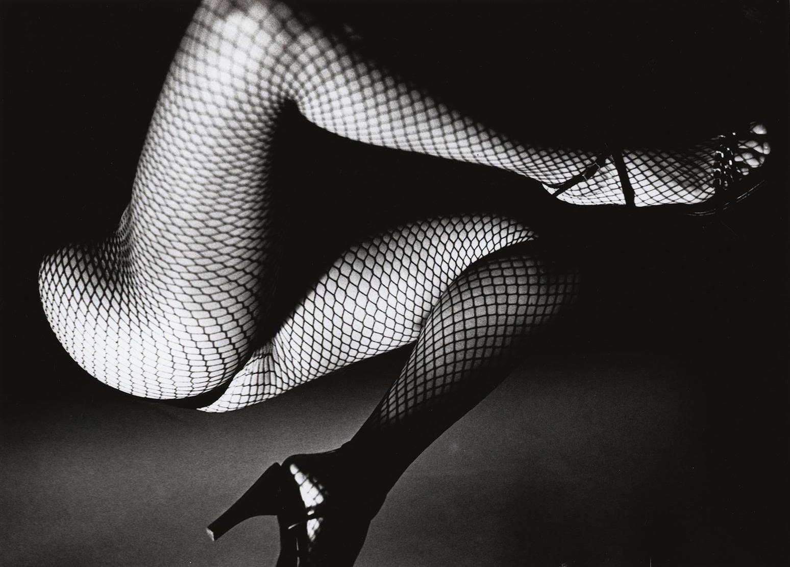 Fernando Natalici 'Tamara Exotica' 1981: 
An anonymous female form seductively twists within the darkness of the frame illuminated just slightly by an unknown source. Featuring black heels and fishnets this high contrast black and white darkroom