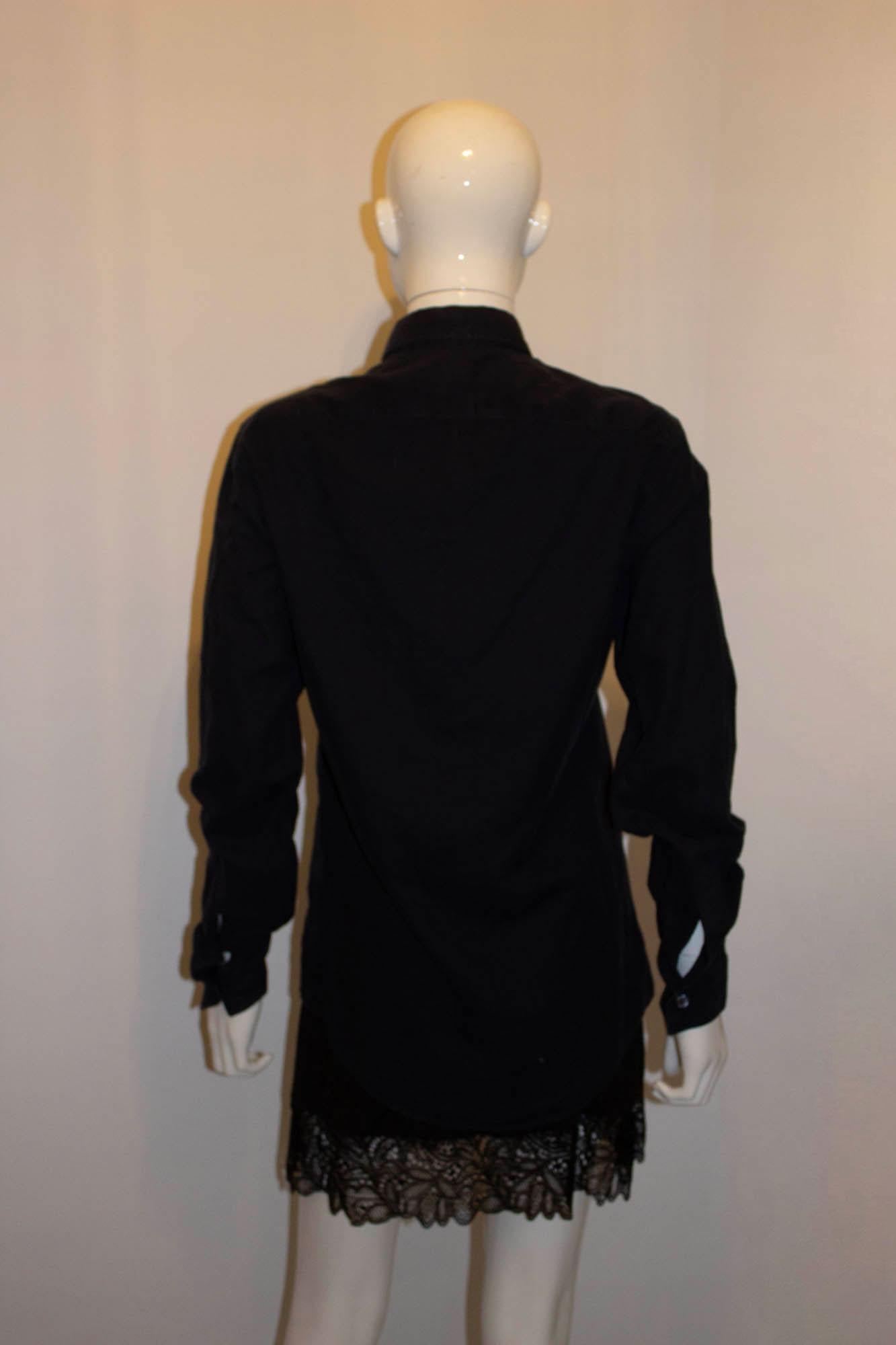 A chic black cotton shirt by Ferragamo. The shirt is made of super soft cotton, and has a button front opening with single button cuffs. Size S Measurements: Chest up to 40'', length 28''