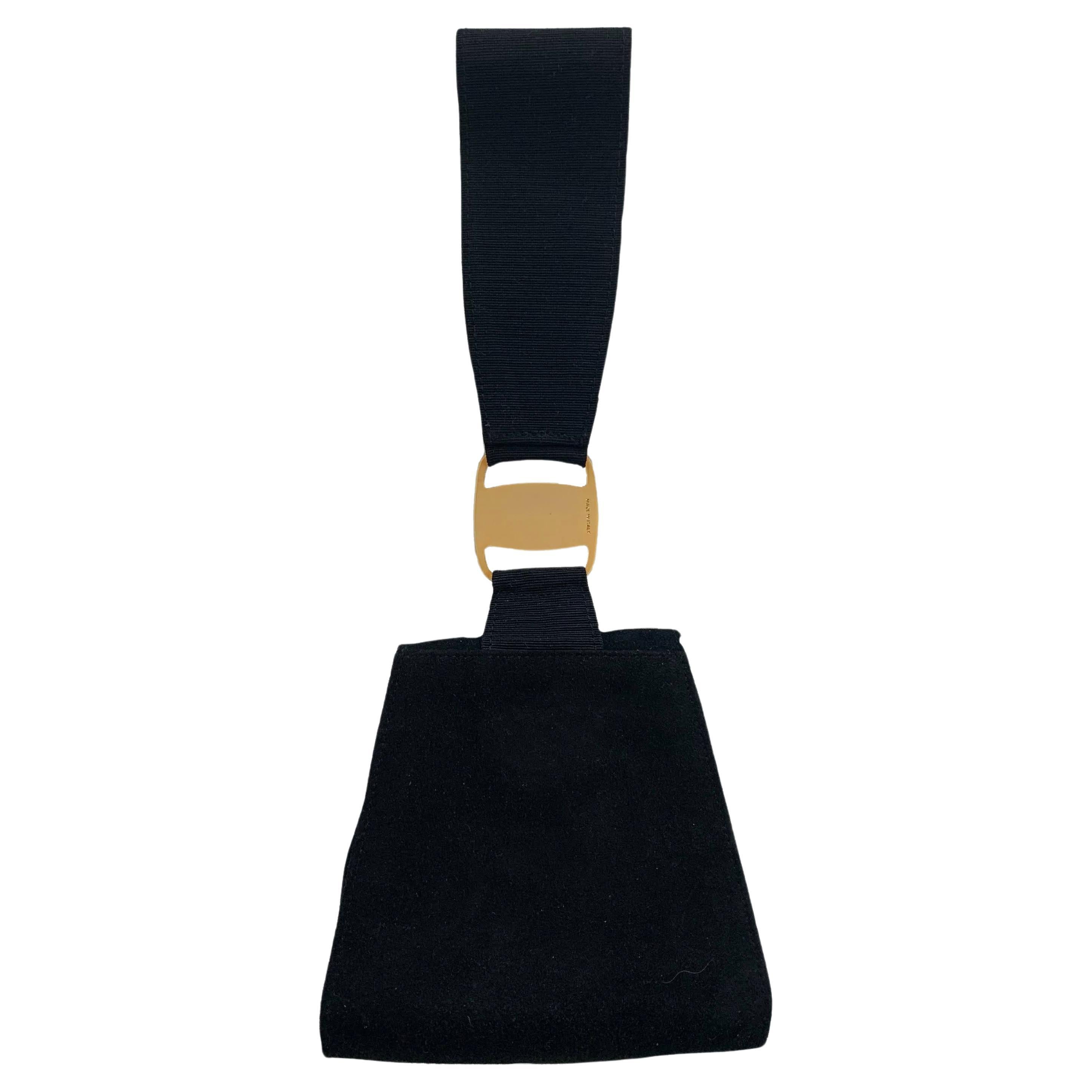 FERRAGAMO SALVATORE. 
Black evening bag.. 
Vintage elegant evening bag in black suede, to be worn hanging on the wrist, arm or hand with a clutch effect thanks to the particular black grosgrain handle, golden hardware element with engraved Ferragamo