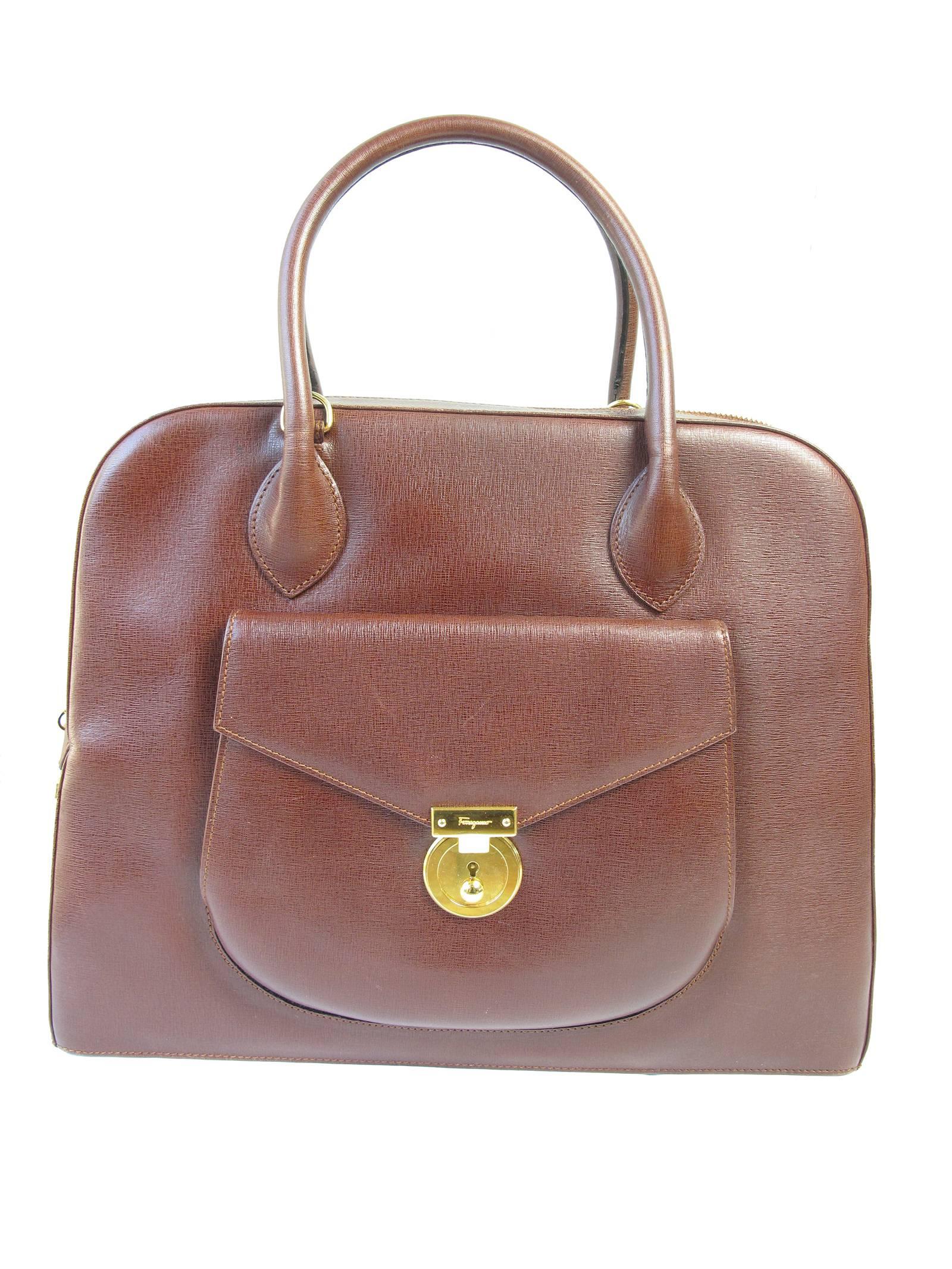 Ferragamo brown leather structured top handle bag with removable strap. Condition: Very good, a few light scratches. Zipper pull locks in place.  Outside pocket. AW21 4742  With lock for exterior pocket.  14