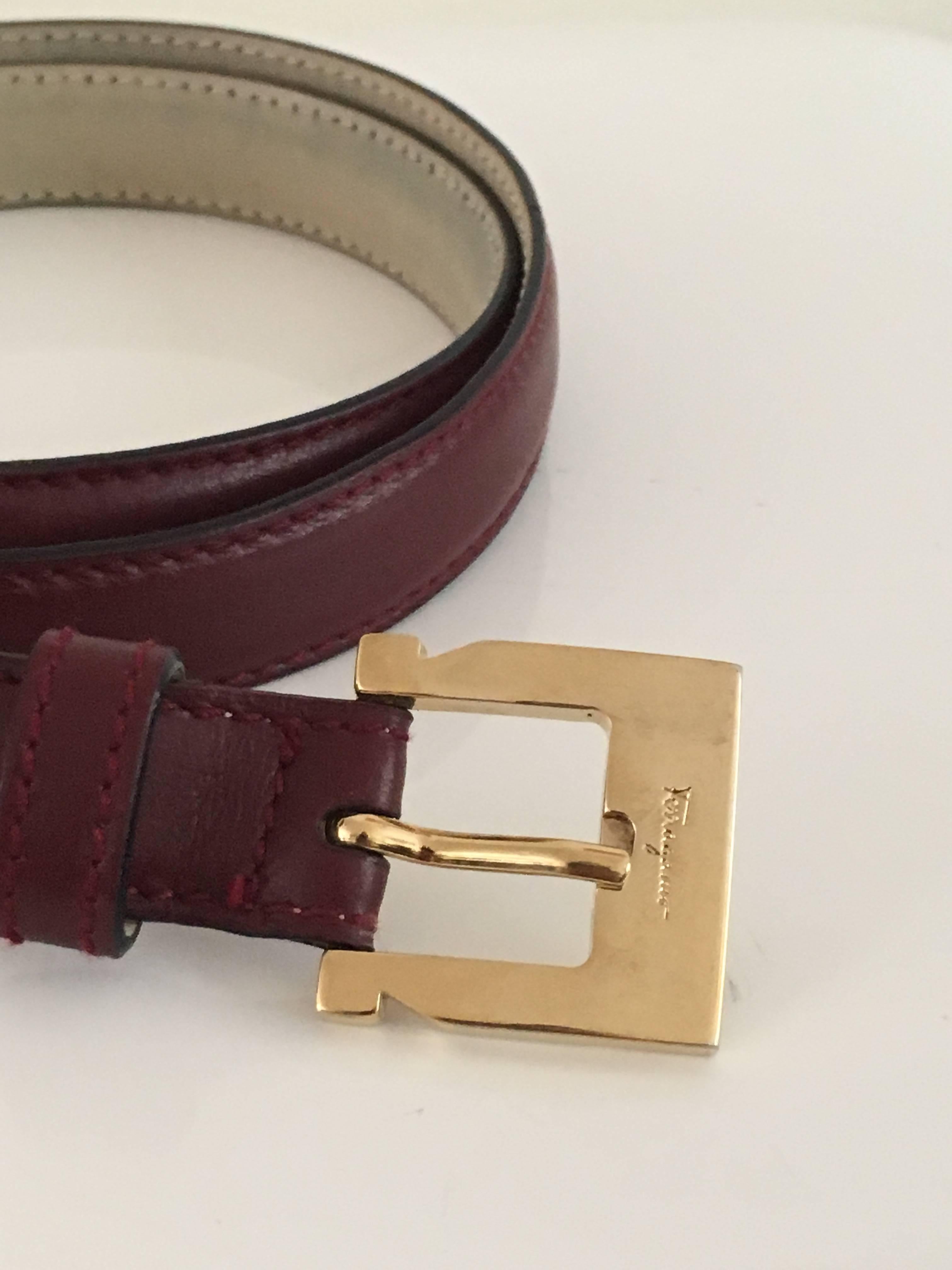 Ferragamo burgundy leather with brass buckle belt is a size medium.
Measurements are:
Buckle:
1. 1/4