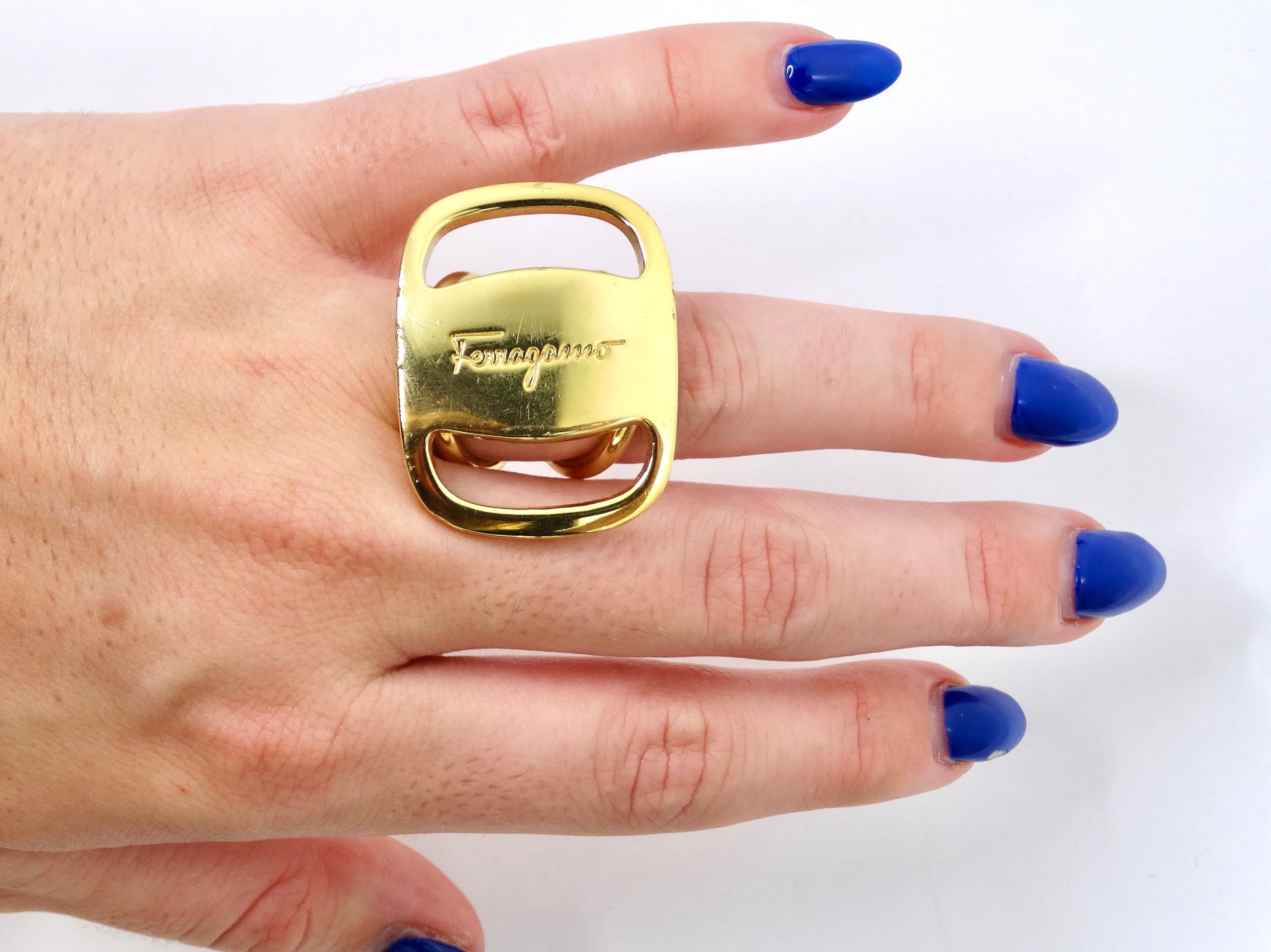 Snag this ultra-fashion forward Ferragamo ring! This is made to make a statement. This can be worn as a ring on your hand or used as a scarf ring. Everyone loves a versatile piece! This is made out of a vibrant gold metal with little imperfections