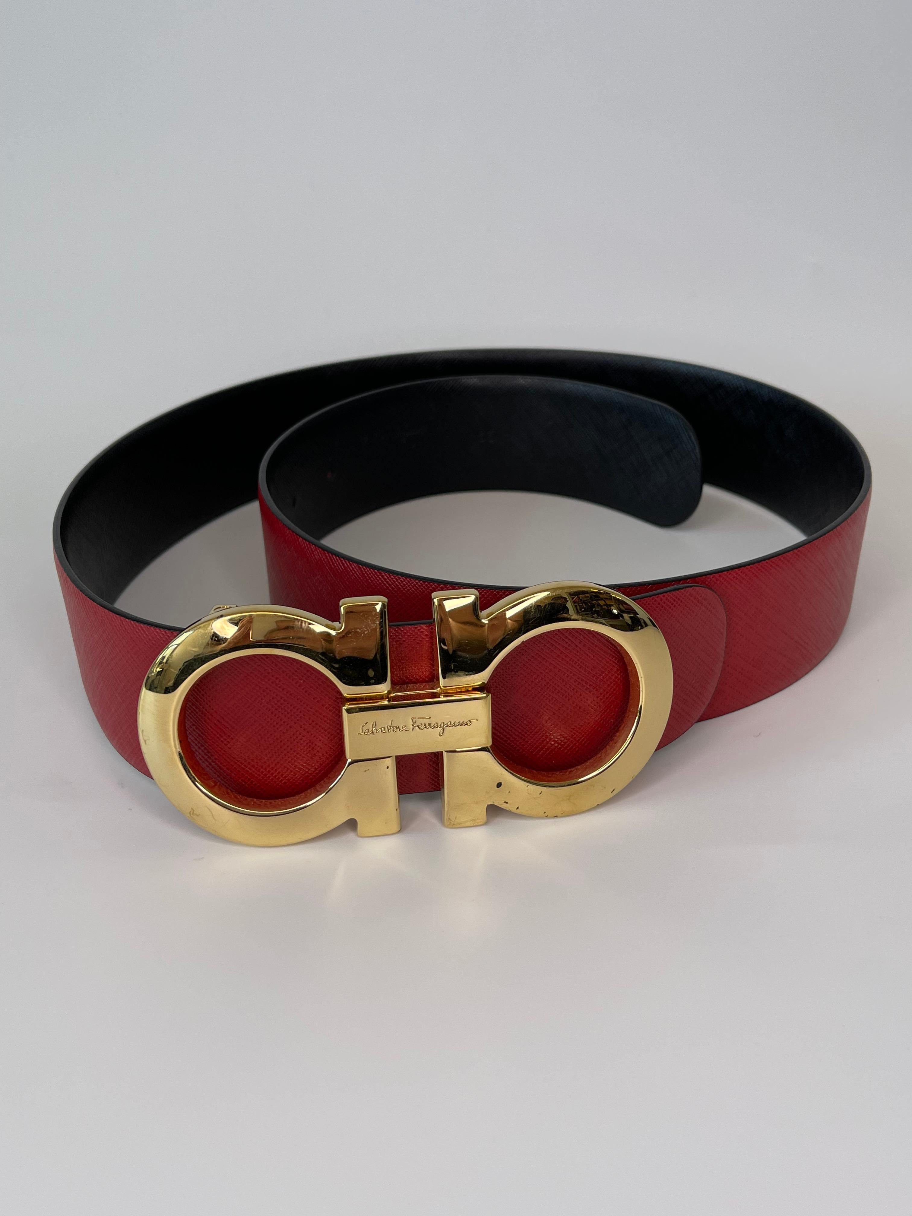 This Salvatore Ferragamo red classic belt consists of a Famous Gancini golden-tone buckle and an adjustable red leather belt body fit. The belt is reversible and can therefore be worn with either the red side or the black side showing. 

COLOR: