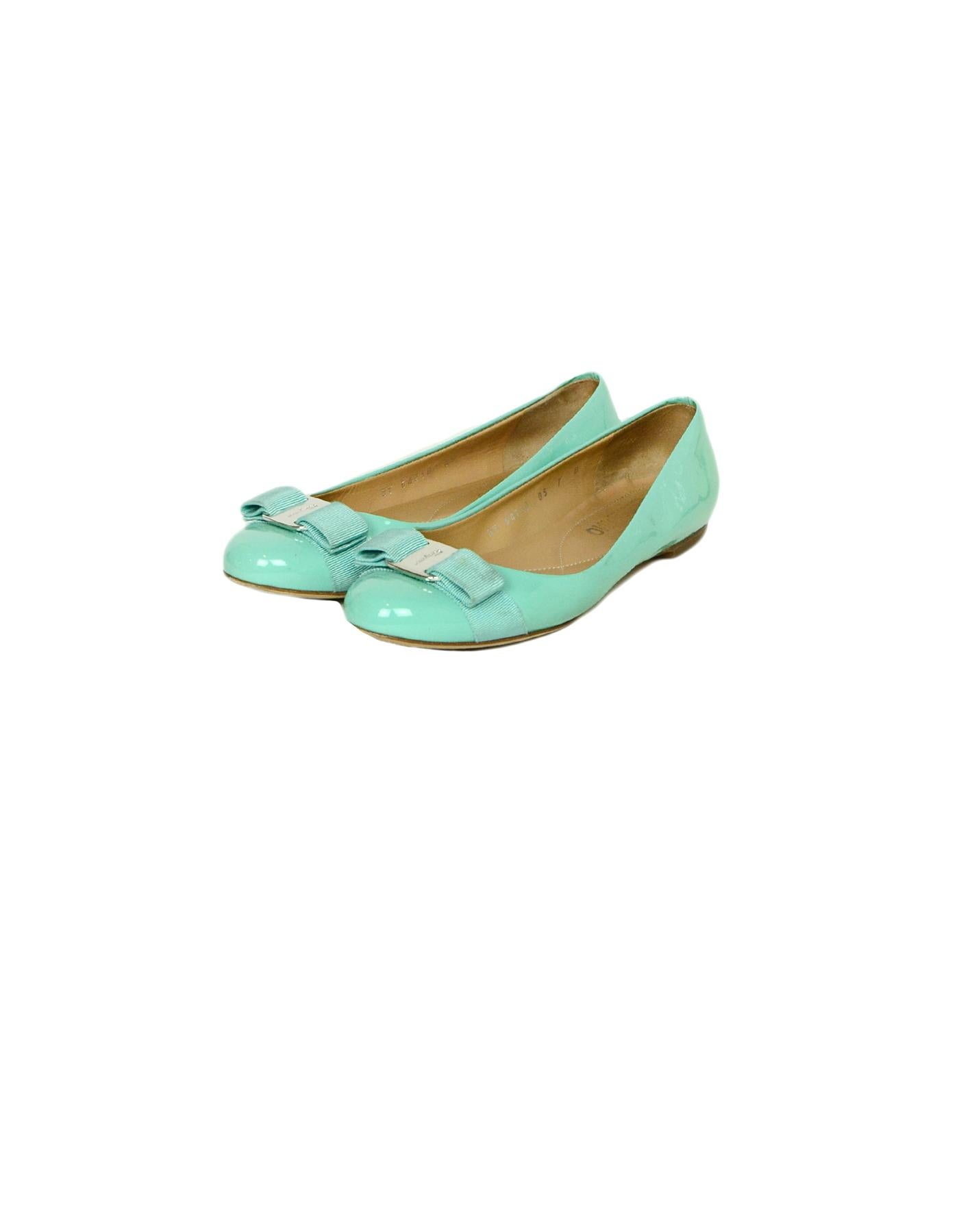 Ferragamo Turquoise Patent Leather Vera Ballet Flats sz 7

Made In: Italy
Color: Turquoise
Hardware: Silvertone
Materials: Patent Leather
Closure/Opening: Slip-on
Overall Condition: Good pre-owned condition, light wear on tips, soles, and insoles.