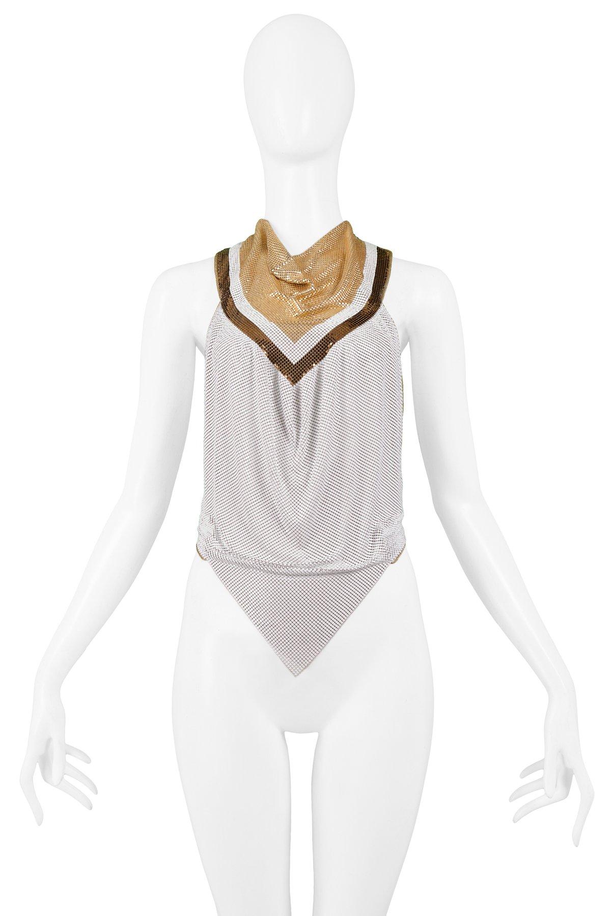 Resurrection Vintage is excited to offer a vintage Anthony Ferrara handmade white, gold, and bronze-tone chainmail metal halter top with a cowl neck, gold leather straps, and diamond front hem. Circa 1980s.

Resurrection is excited to present the