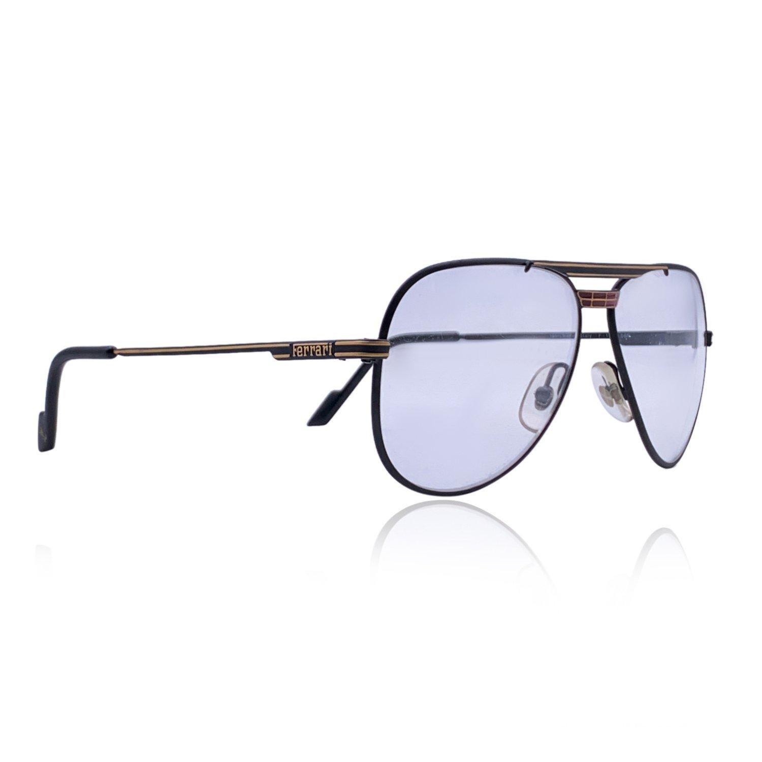 Black metal eyeglasses by Ferrari. Aviator design. Model: F 13/1 - col. 586. Size: 59/13. Enameled accents on the nose bridge. Clear demo lenses. Hand Made in Italy Details MATERIAL: Metal COLOR: Black MODEL: F 13/1 GENDER: Unisex Adults COUNTRY OF