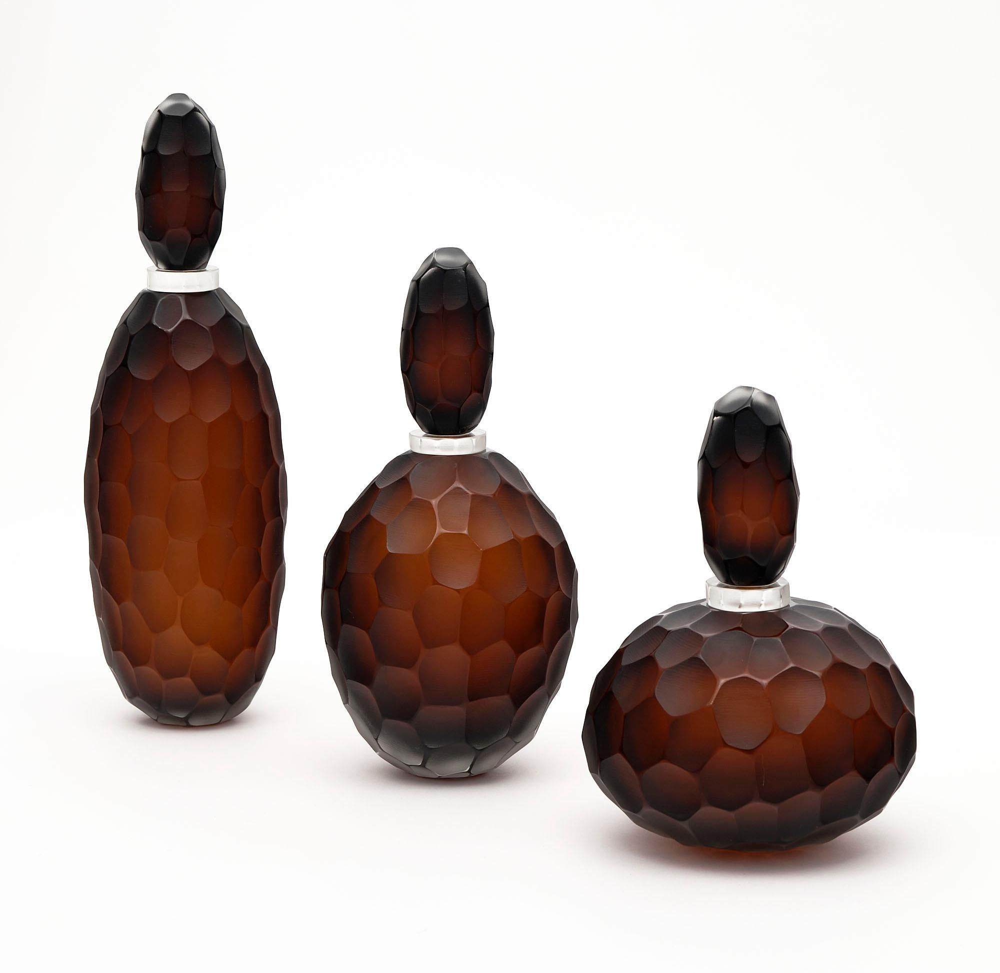 Murano glass “ferro battuto” bottles. This beautiful trio is hand-blown using this hammered technique in the manner of Carlo Scarpa. We love the striking color and depth to these works of art. They are signed by glass maestro Alberto Dona.

The