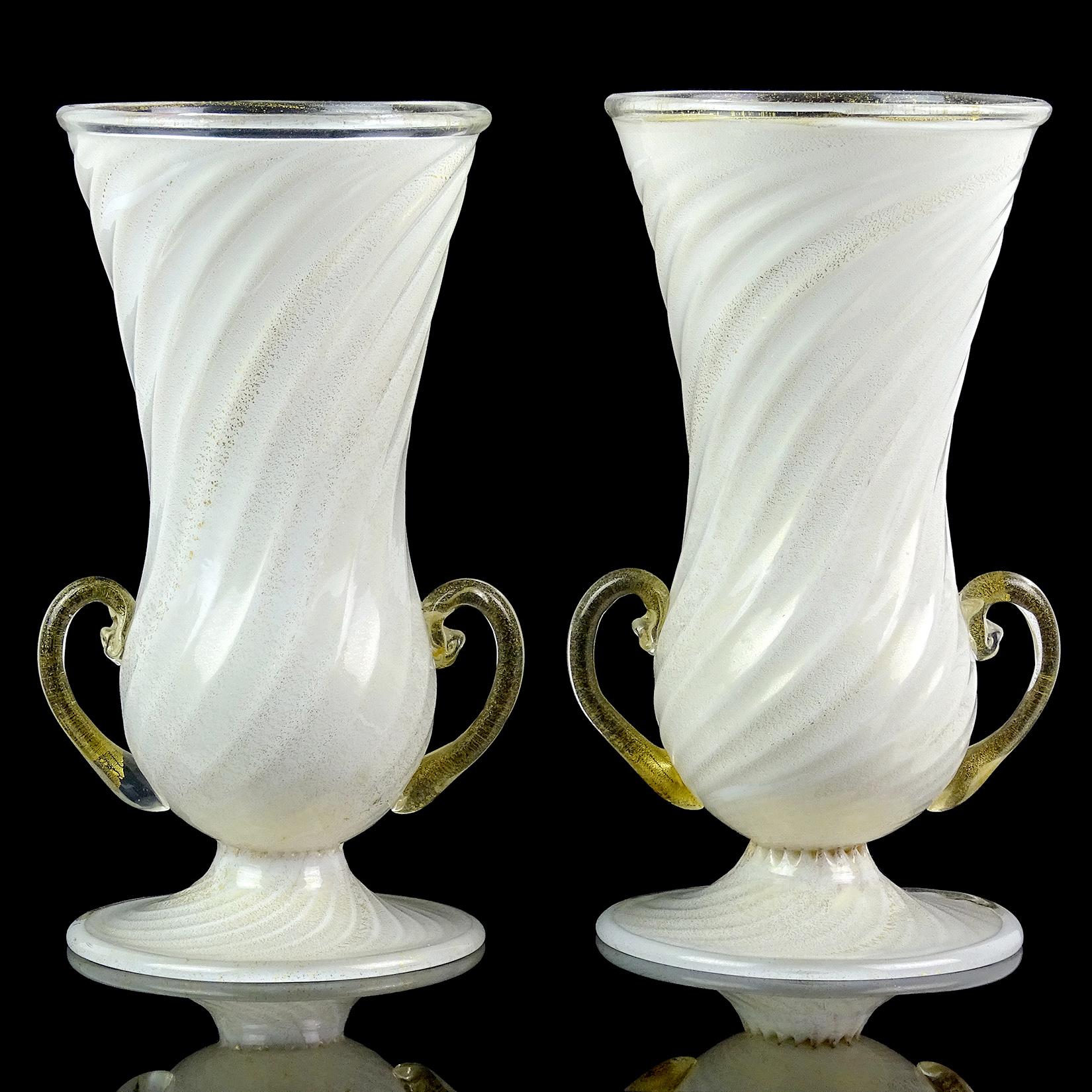 Beautiful and rare, matching antique Murano hand blown white and gold flecks Italian art glass double handles flower vases. Documented to the Ferro Toso Barovier Vetreria Artistiche Riunite S. A. company, circa 1939-1942. One of the vases still