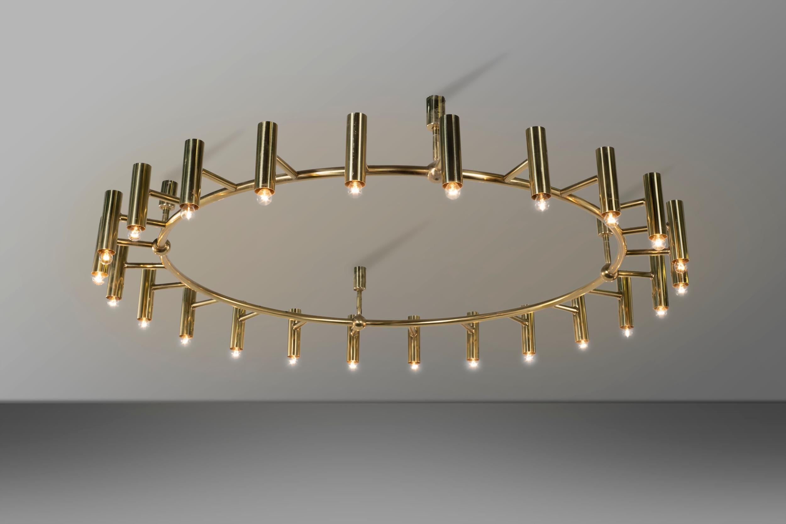 Big circular brass chandelier with 24 lights. This chandelier comes form the important restaurant designed by Ferruccio Laviani for Dolce&Gabbana in the early 2000 and closed around the 2015. The elegant but impressive shape gives the room a sober