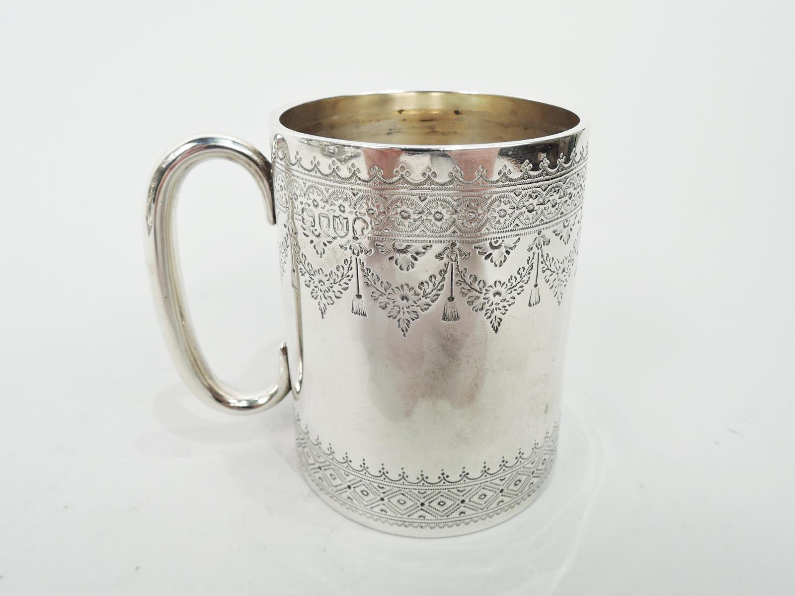 Victorian sterling silver baby cup. Made by John Aldwinckle & Thomas Slater in London in 1887. Straight and gently upward tapering sides and c-scroll handle. Ornamental borders engraved at top and bottom including ribbon-tied garlands. Festive and